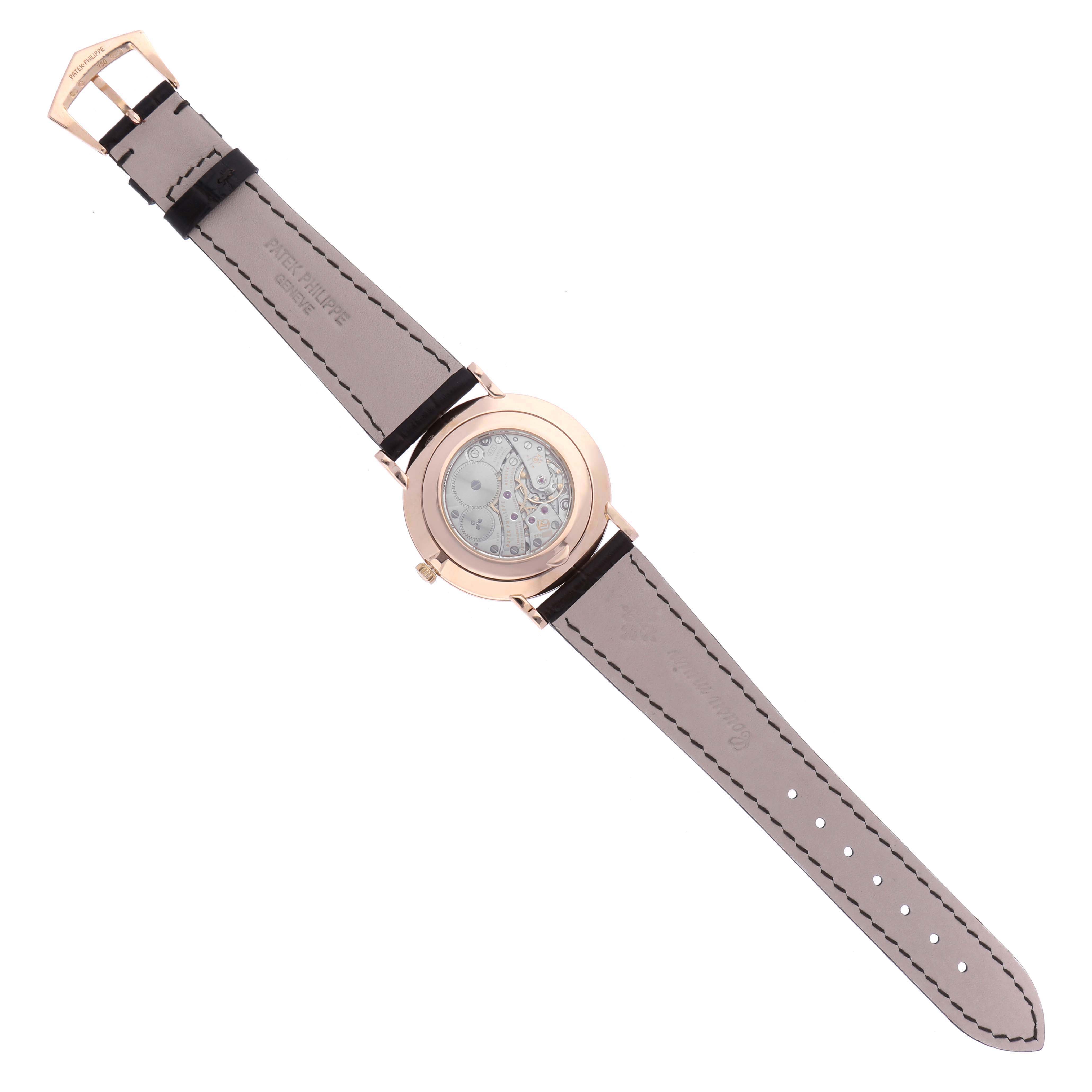 The Patek Philippe Calatrava 5119R-001 Men
s Rose Gold White Dial 5119R-001 Men
s Rose Gold White Dial watch is shown from the back, displaying its movement and full leather strap.