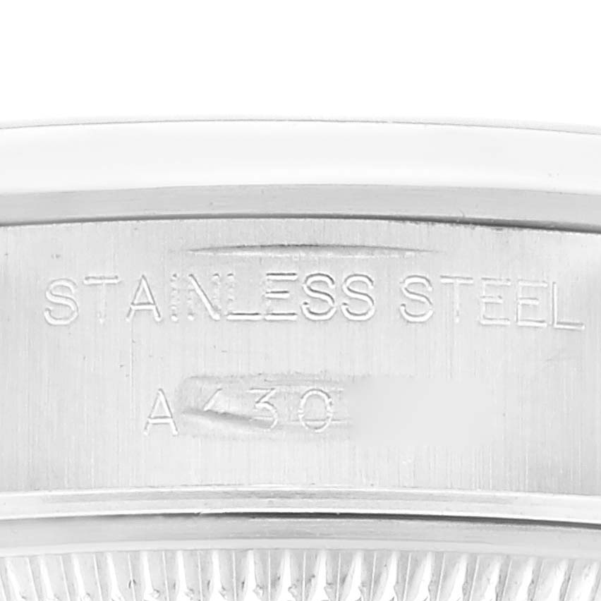 The image shows a close-up of the engraved text on the stainless steel part of a Rolex Date 69160 Women
s Stainless Steel Blue Dial 69160 Women
s Stainless Steel Blue Dial model watch.