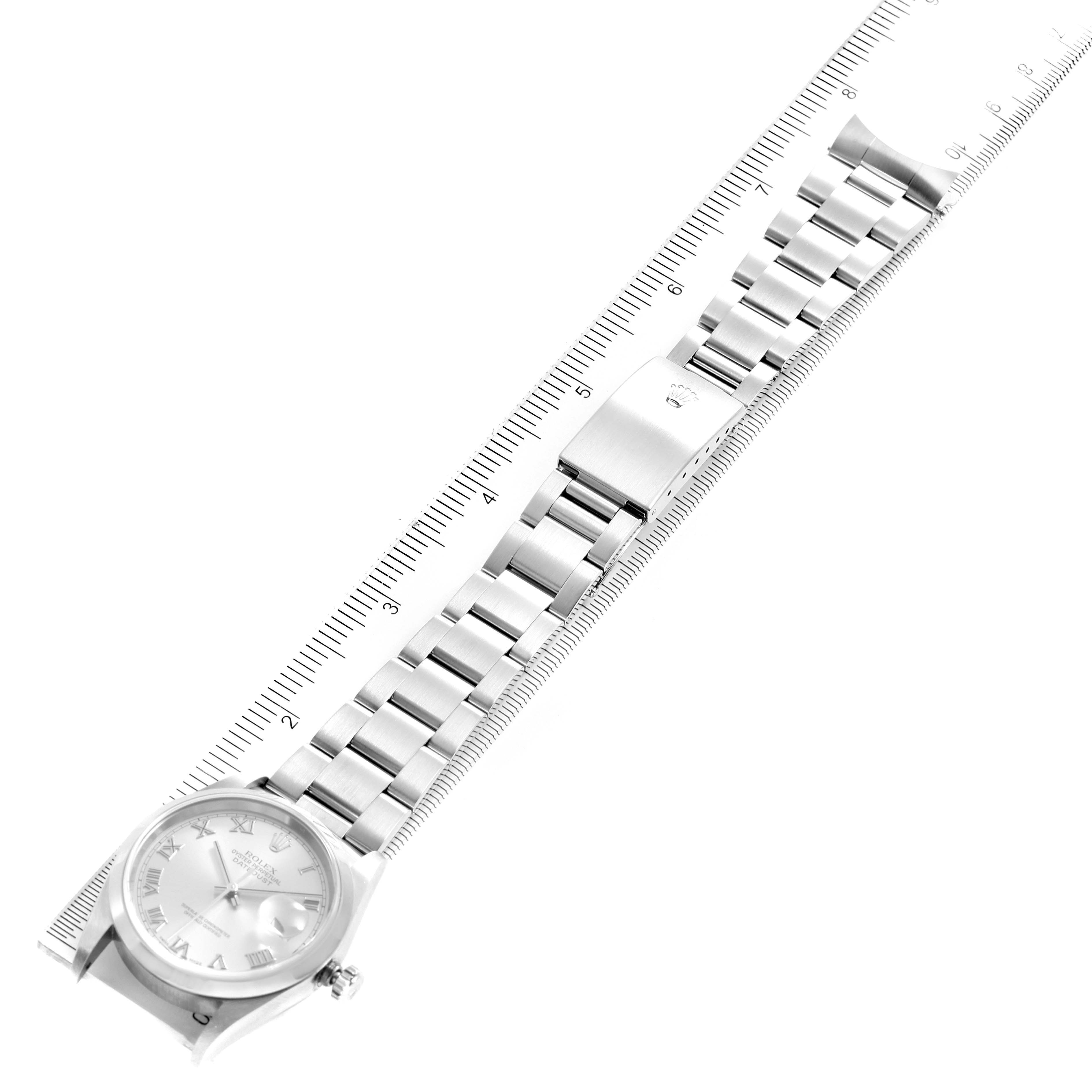 This image shows a Rolex Datejust 16200 Men's Stainless Steel Grey Dial 16200 Men's Stainless Steel Grey Dial watch laid flat with its band and clasp aligned next to a ruler for size reference.