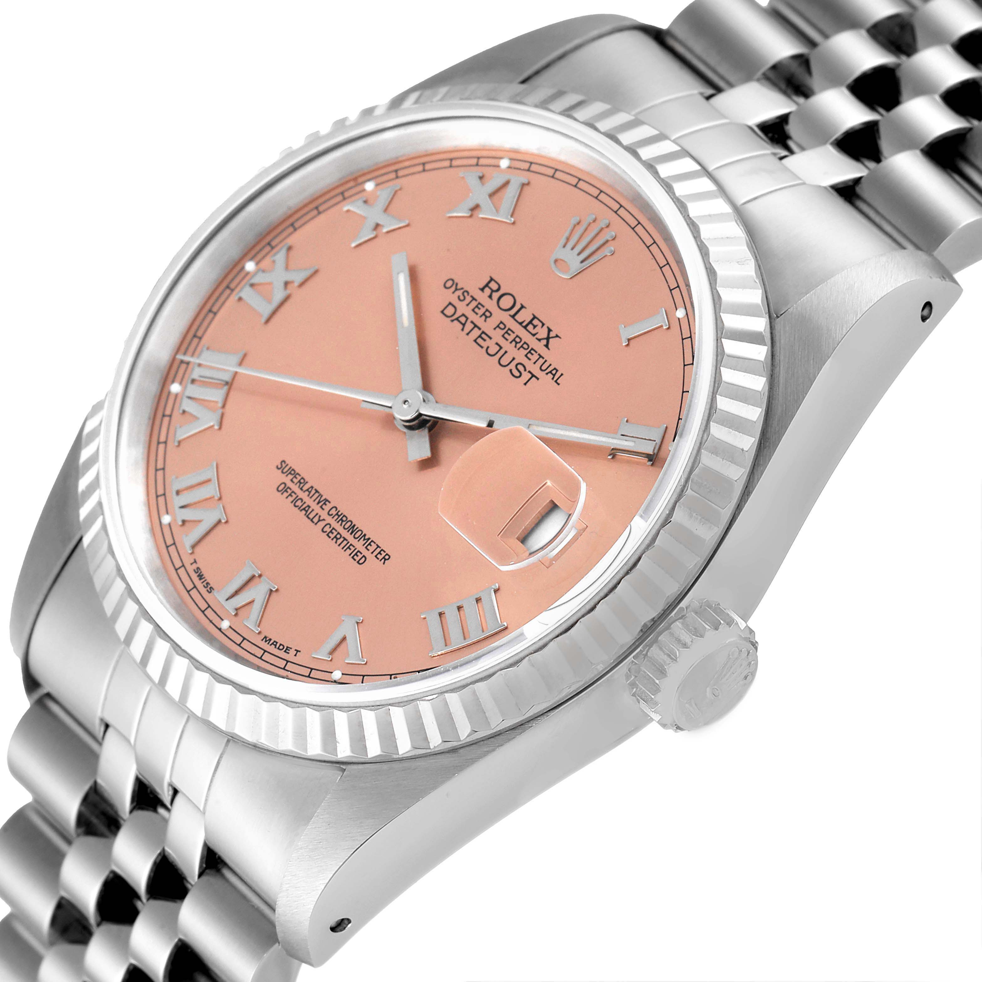 This image shows a close-up of the Rolex Datejust 16234 Men
s Stainless Steel Pink Dial 16234 Men
s Stainless Steel Pink Dial watch, highlighting the face, fluted bezel, crown, and part of the bracelet from an angled side view.