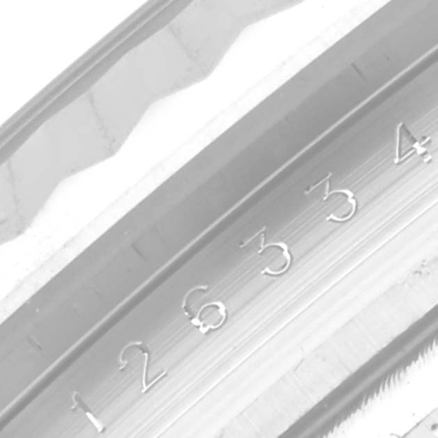 This image shows a close-up of the fluted bezel and partially visible dial of the Rolex Datejust 41 126334NG Men
s Stainless Steel Mother of Pearl Dial 126334NG Men
s Stainless Steel Mother of Pearl Dial watch.