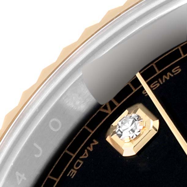 This image shows a close-up of the bezel, part of the dial, and a diamond hour marker of a Rolex Datejust 41 M126333-0012 Men's Steel and Gold (two tone) Black Dial M126333-0012 Men's Steel and Gold (two tone) Black Dial watch.