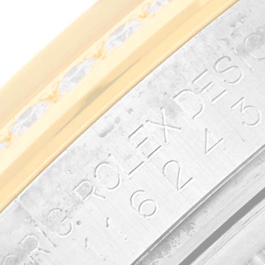 This close-up image shows part of the bezel and edge of the case of a Rolex Datejust 116243 Men's Steel and Gold (two tone) Champagne Dial 116243 Men's Steel and Gold (two tone) Champagne Dial watch.
