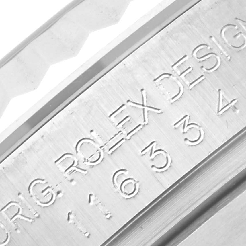 This close-up image shows the engraved serial and model numbers on the Rolex Datejust 41 116334 Men
s Stainless Steel Silver Dial 116334 Men
s Stainless Steel Silver Dial
s brushed metal case back.