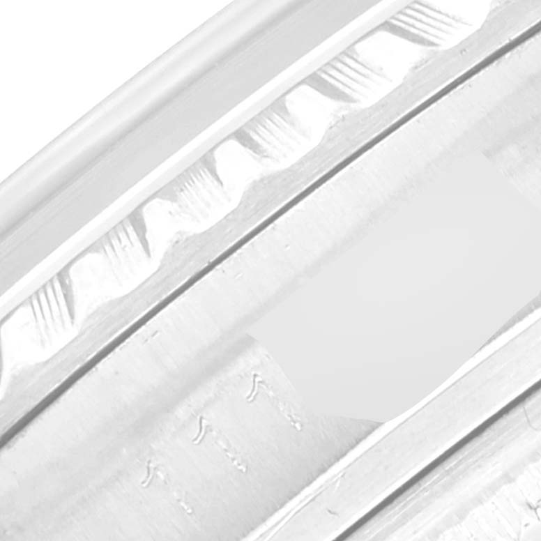 This close-up of a Rolex Vintage Collection 1603 Men's Stainless Steel Silver Dial 1603 Men's Stainless Steel Silver Dial watch shows the detailed edge and part of the bezel.