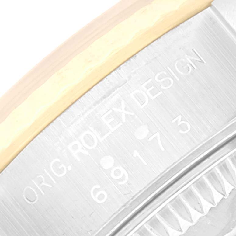 This image shows a close-up of the serial number and "ORIG. ROLEX DESIGN" engraving on the case side of a Rolex Datejust 69173 Women's Steel and Gold (two tone) Champagne Dial 69173 Women's Steel and Gold (two tone) Champagne Dial watch.