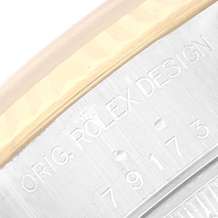 A close-up angle showing the engraved "ROLEX DESIGN" and serial number on the casing of a Rolex Datejust 79173 Women's Steel and Gold (two tone) Silver Dial 79173 Women's Steel and Gold (two tone) Silver Dial watch.