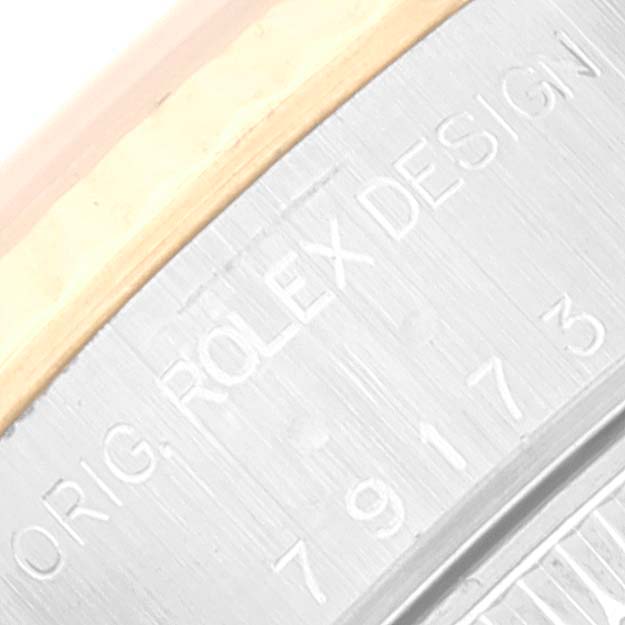 The image shows a close-up of the bezel and serial number engraving on a Rolex Datejust 79173 Women's Steel and Gold (two tone) Grey Dial 79173 Women's Steel and Gold (two tone) Grey Dial watch.