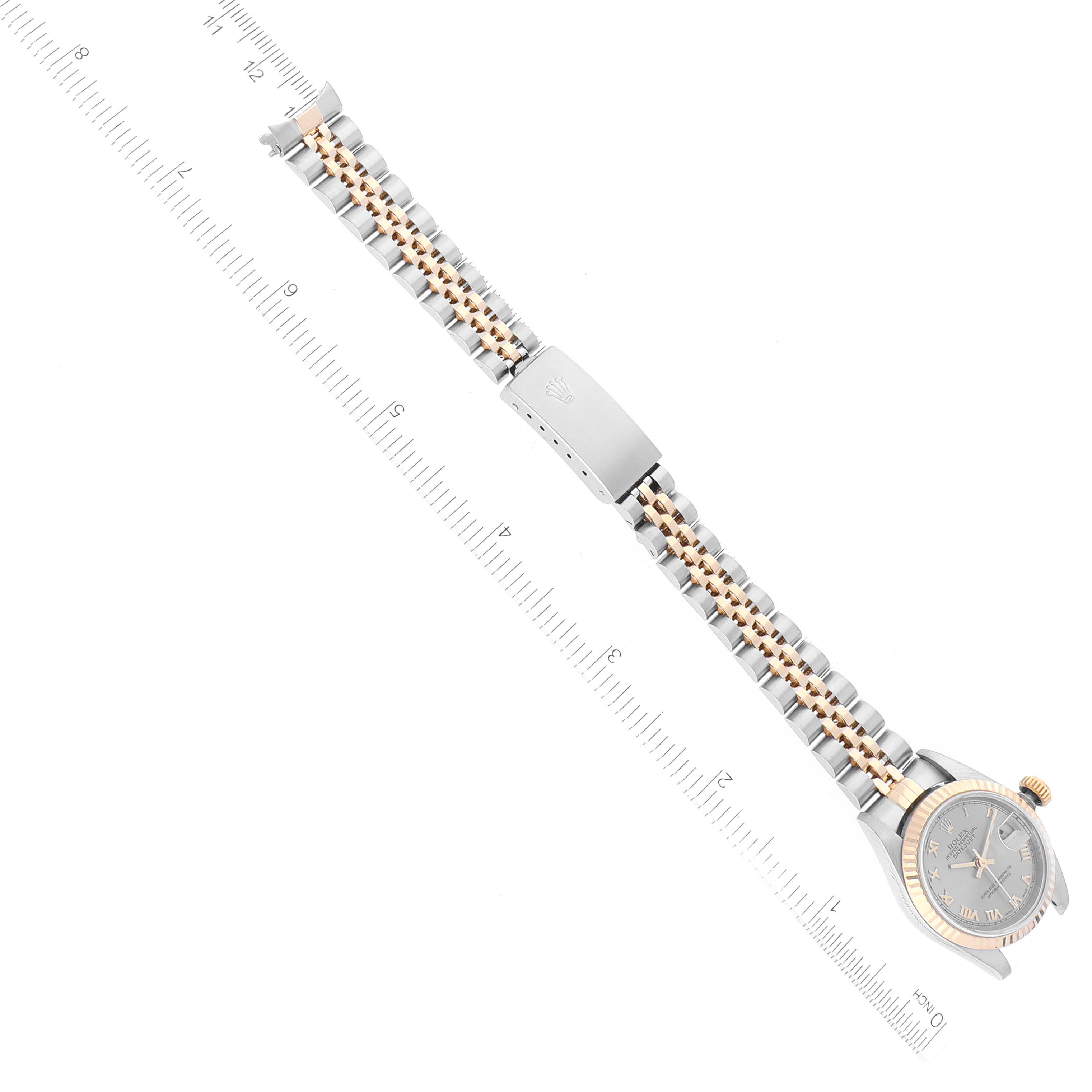 The image shows a Rolex Datejust 79173 Women's Steel and Gold (two tone) Grey Dial 79173 Women's Steel and Gold (two tone) Grey Dial watch laid flat with a ruler for scale, displaying the face, bracelet, and clasp.