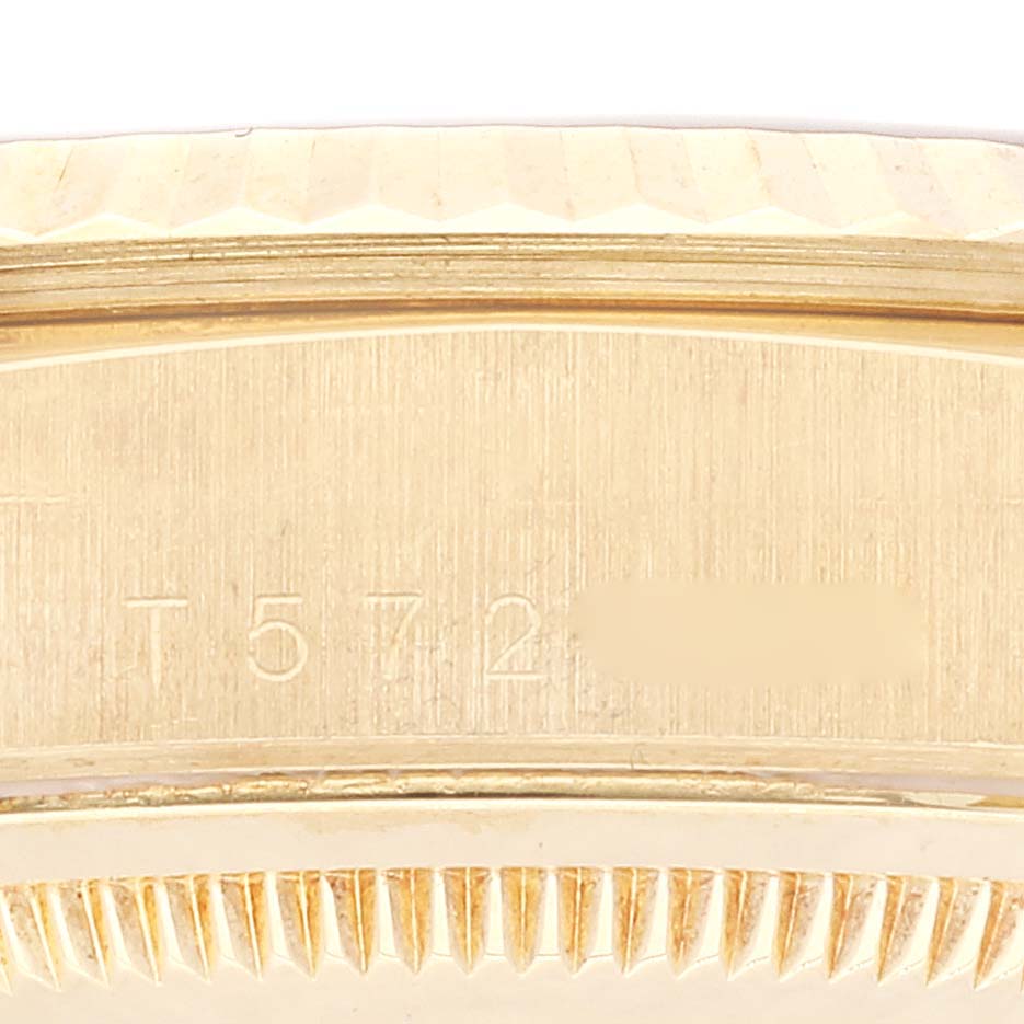 This image shows an up-close view of the serial number and bezel of a Rolex President 18238 Men
s Yellow Gold Champagne Dial 18238 Men
s Yellow Gold Champagne Dial model watch.