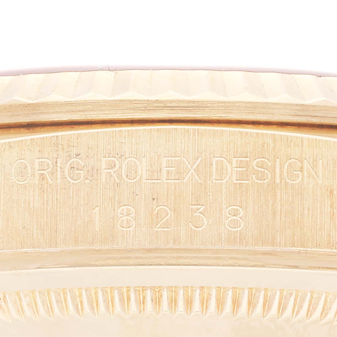 This close-up image shows the side view of a Rolex President 18238 Men
s Yellow Gold Champagne Dial 18238 Men
s Yellow Gold Champagne Dial model watch, highlighting its serial number and engravings.