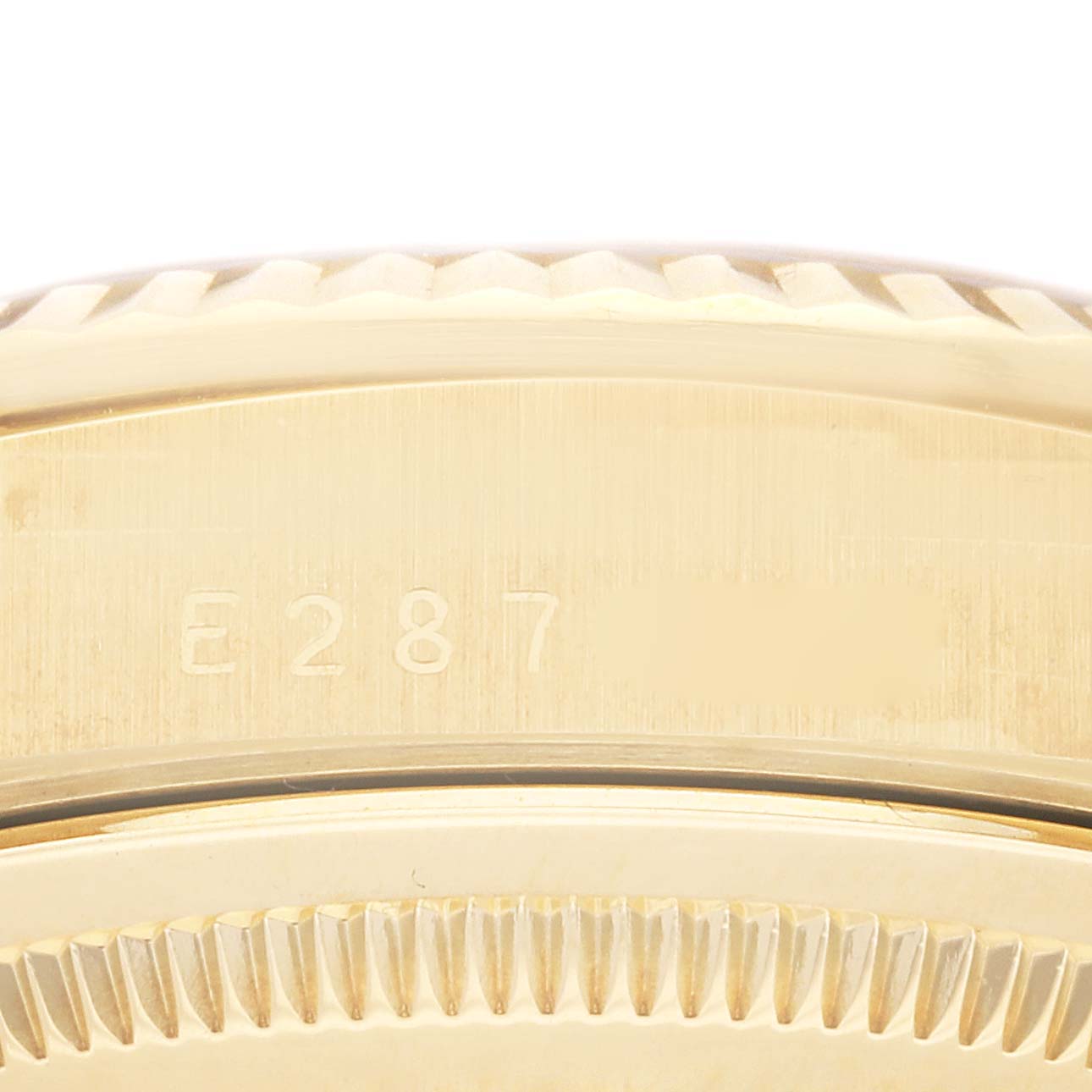 This image shows a close-up of the side of the case and bezel of a Rolex President 18238 Men
s Yellow Gold Champagne Dial 18238 Men
s Yellow Gold Champagne Dial model watch, showcasing the serial number.