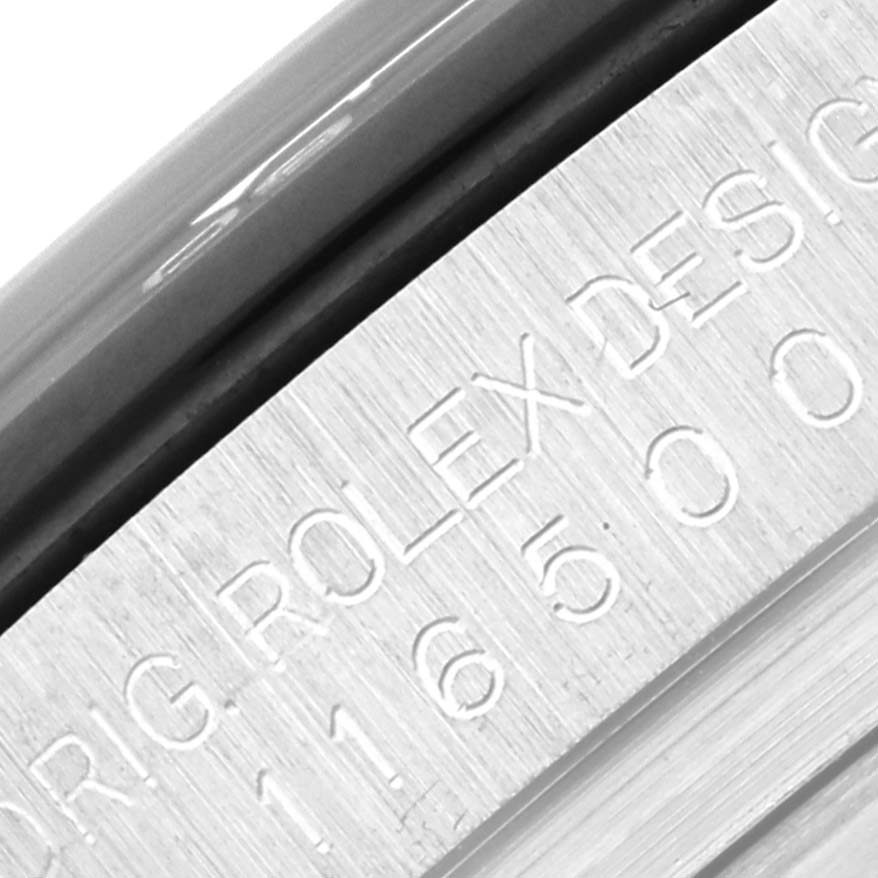 This close-up angle shows the engraved serial numbers and part of the case rim of a Rolex Daytona 116500LN Men's Stainless Steel Black Dial 116500LN Men's Stainless Steel Black Dial watch.