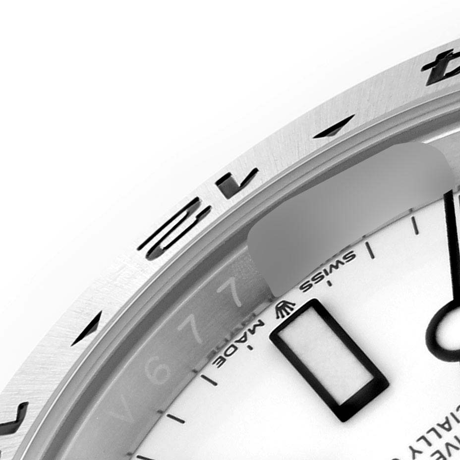 This image shows a close-up of the dial and bezel of a Rolex Explorer 226570 Men's Stainless Steel White Dial 226570 Men's Stainless Steel White Dial watch, including parts of the hour markers and Swiss Made text.