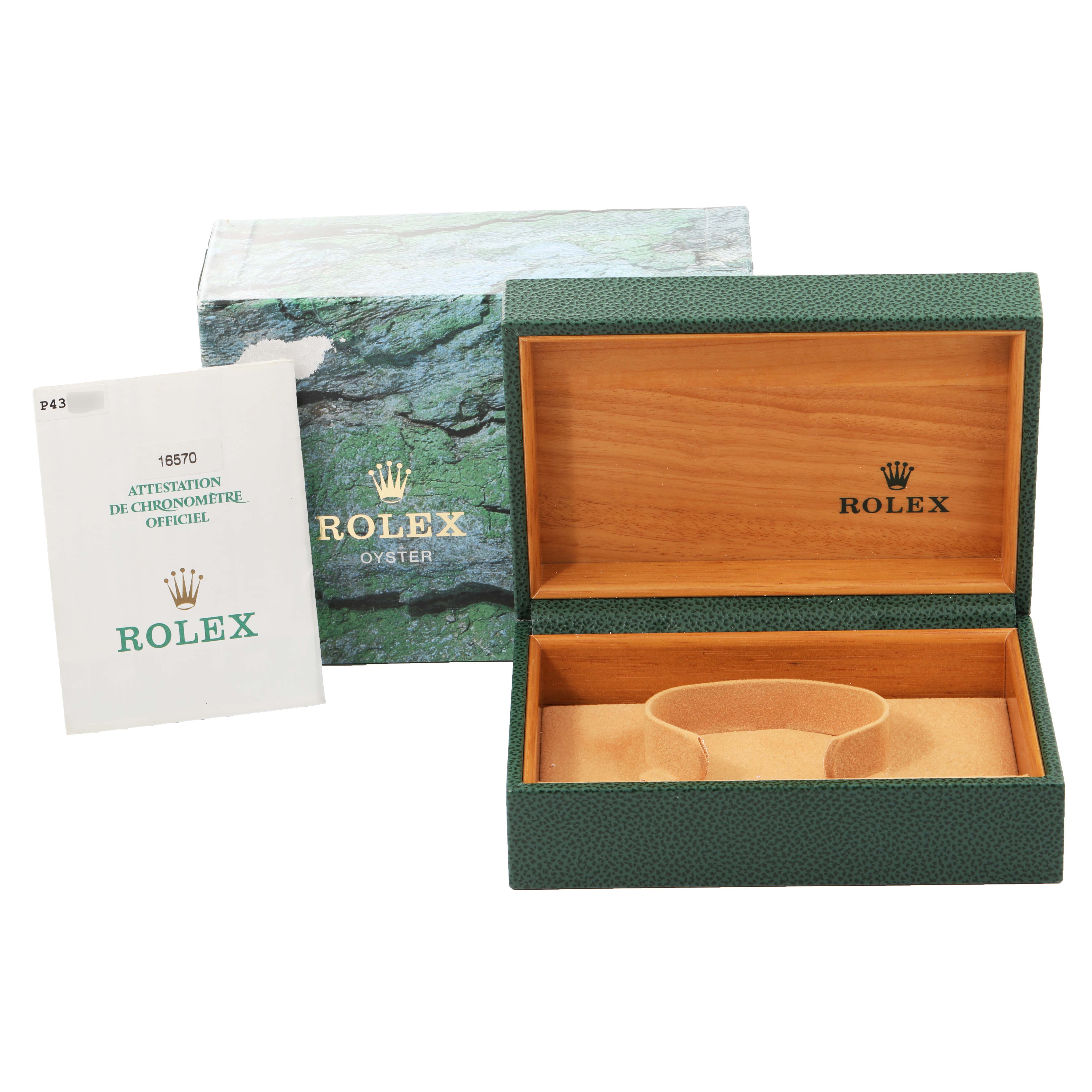 This image shows the packaging and accessories for a Rolex Explorer 16570 Men
s Stainless Steel Black Dial 16570 Men
s Stainless Steel Black Dial model, including the open green watch box and official documentation.