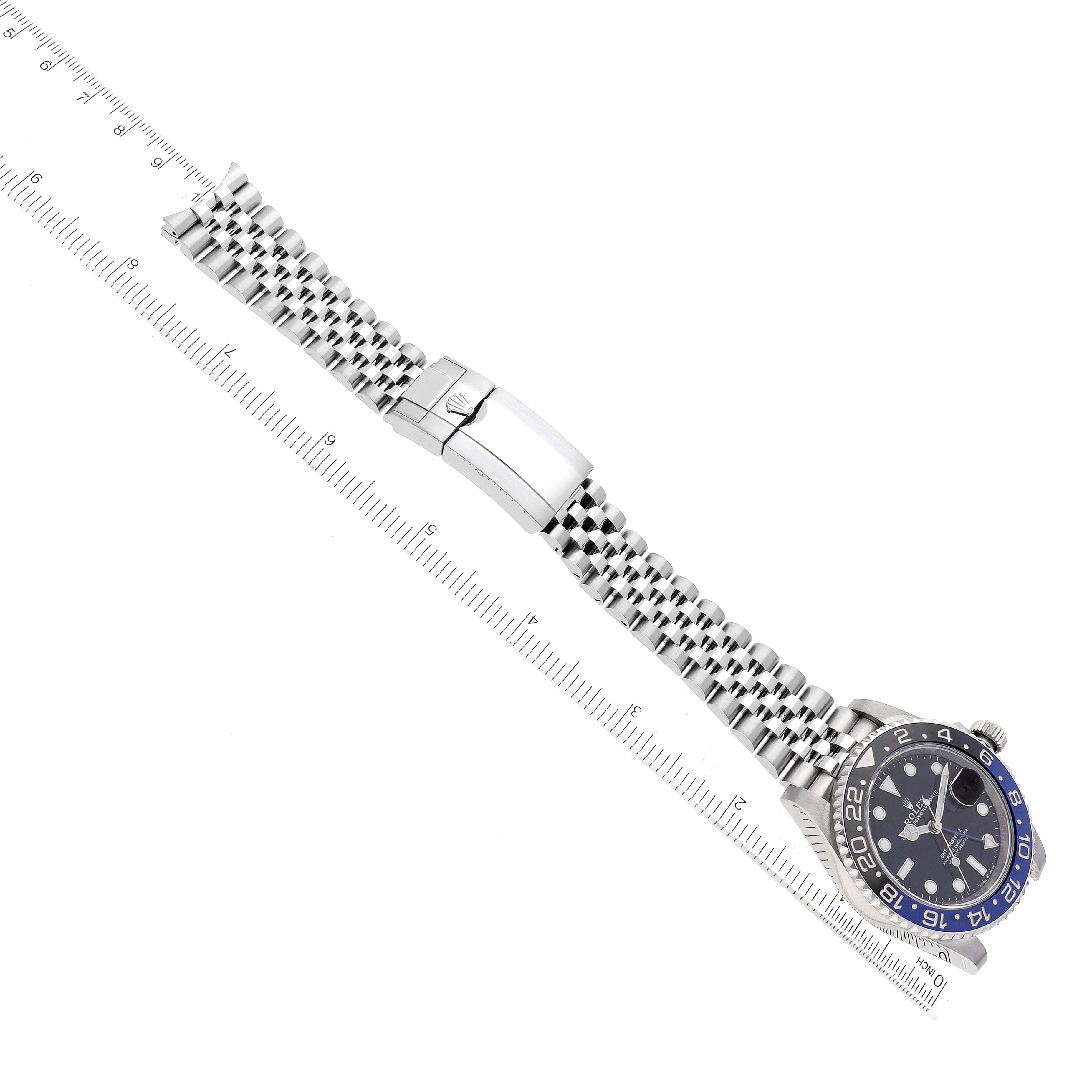 The image shows a Rolex GMT-Master 126710BLNR Men
s Stainless Steel Black Dial 126710BLNR Men
s Stainless Steel Black Dial watch at an oblique angle, highlighting its face, bracelet, and clasp with a ruler for scale.