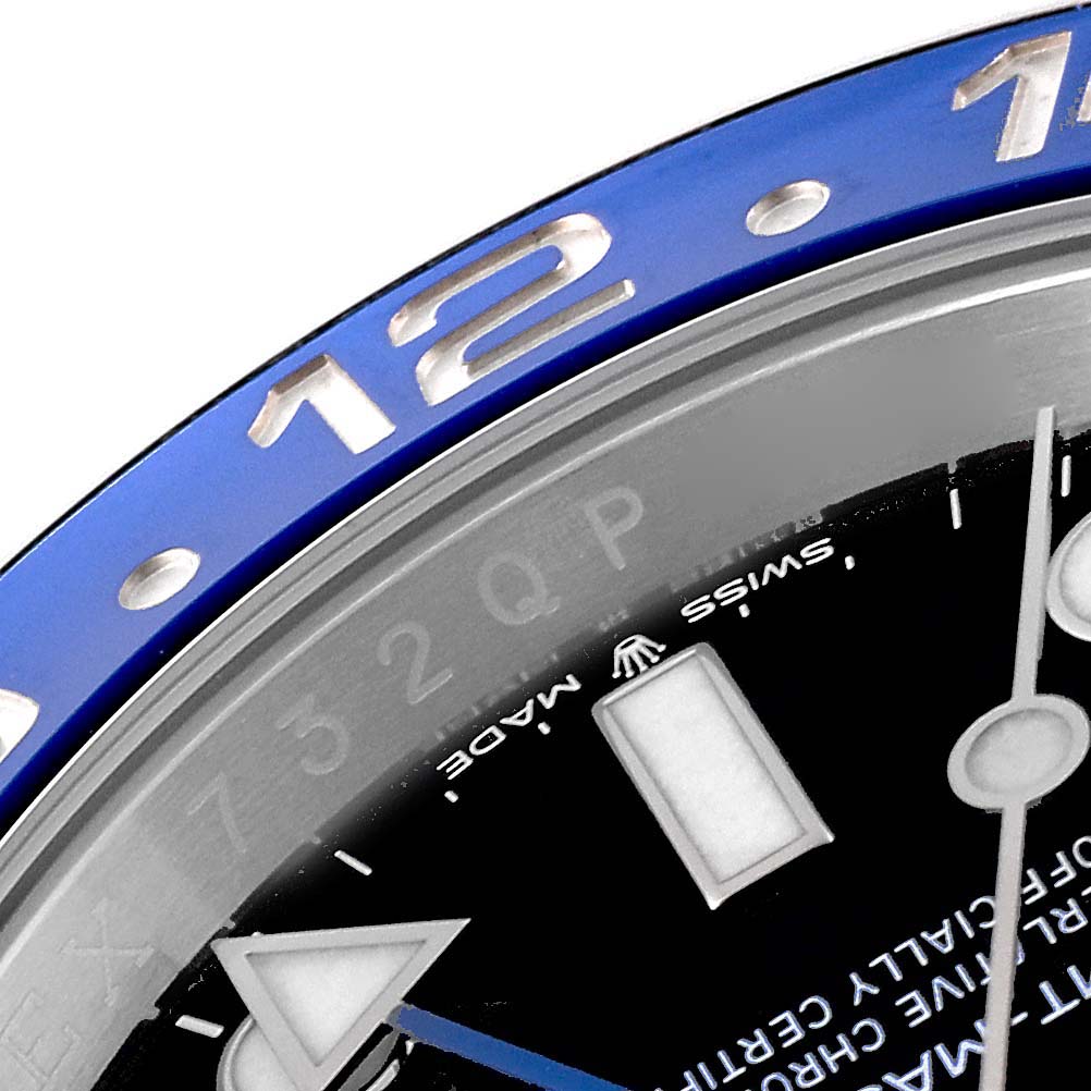 This image shows a close-up of the bezel and dial of a Rolex GMT-Master 126710BLNR Men
s Stainless Steel Black Dial 126710BLNR Men
s Stainless Steel Black Dial watch, highlighting the 12-hour mark.