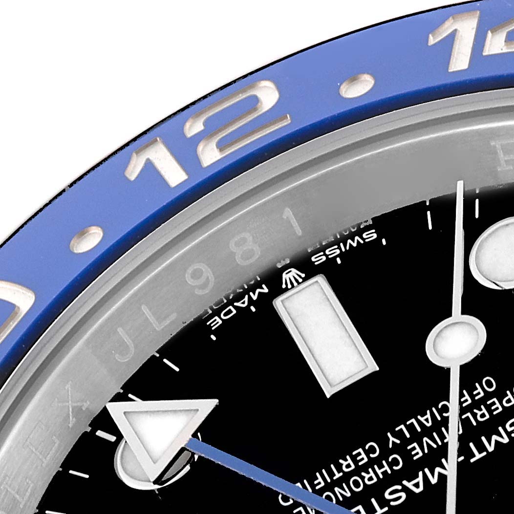 Close-up of the dial and bezel of the Rolex GMT-Master 126710BLNR Men
s Stainless Steel Black Dial 126710BLNR Men
s Stainless Steel Black Dial, showing the 12-hour marker and part of the "SWISS MADE" text.