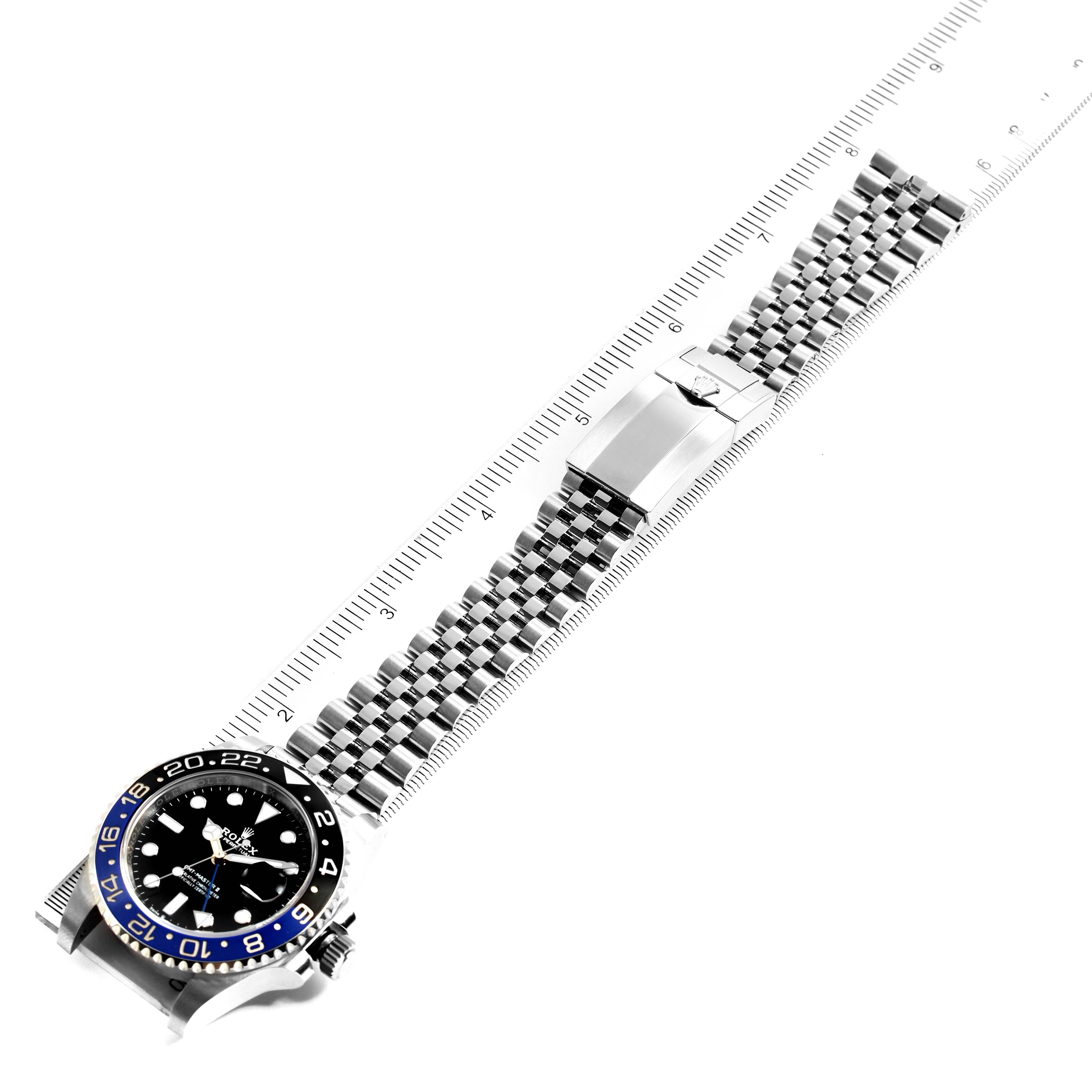 The image shows a top-down view of a Rolex GMT-Master 126710 Men's Stainless Steel Black Dial 126710 Men's Stainless Steel Black Dial, displaying the face, bezel, crown, and entire bracelet placed alongside a ruler.