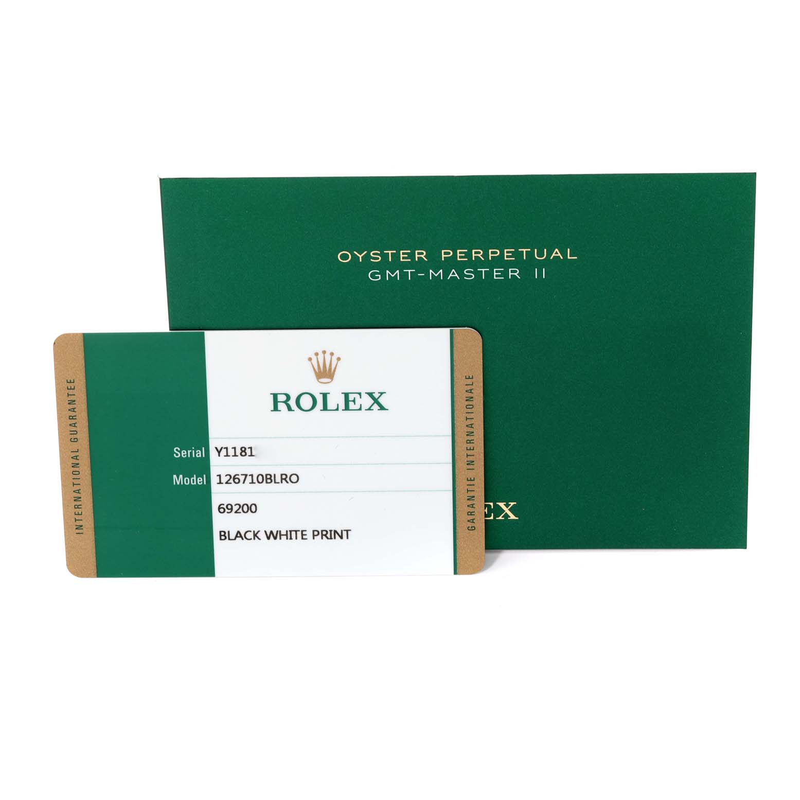 The image shows the international guarantee card and the green box for the Rolex GMT-Master 126710BLRO Men
s Stainless Steel Black Dial 126710BLRO Men
s Stainless Steel Black Dial II watch.