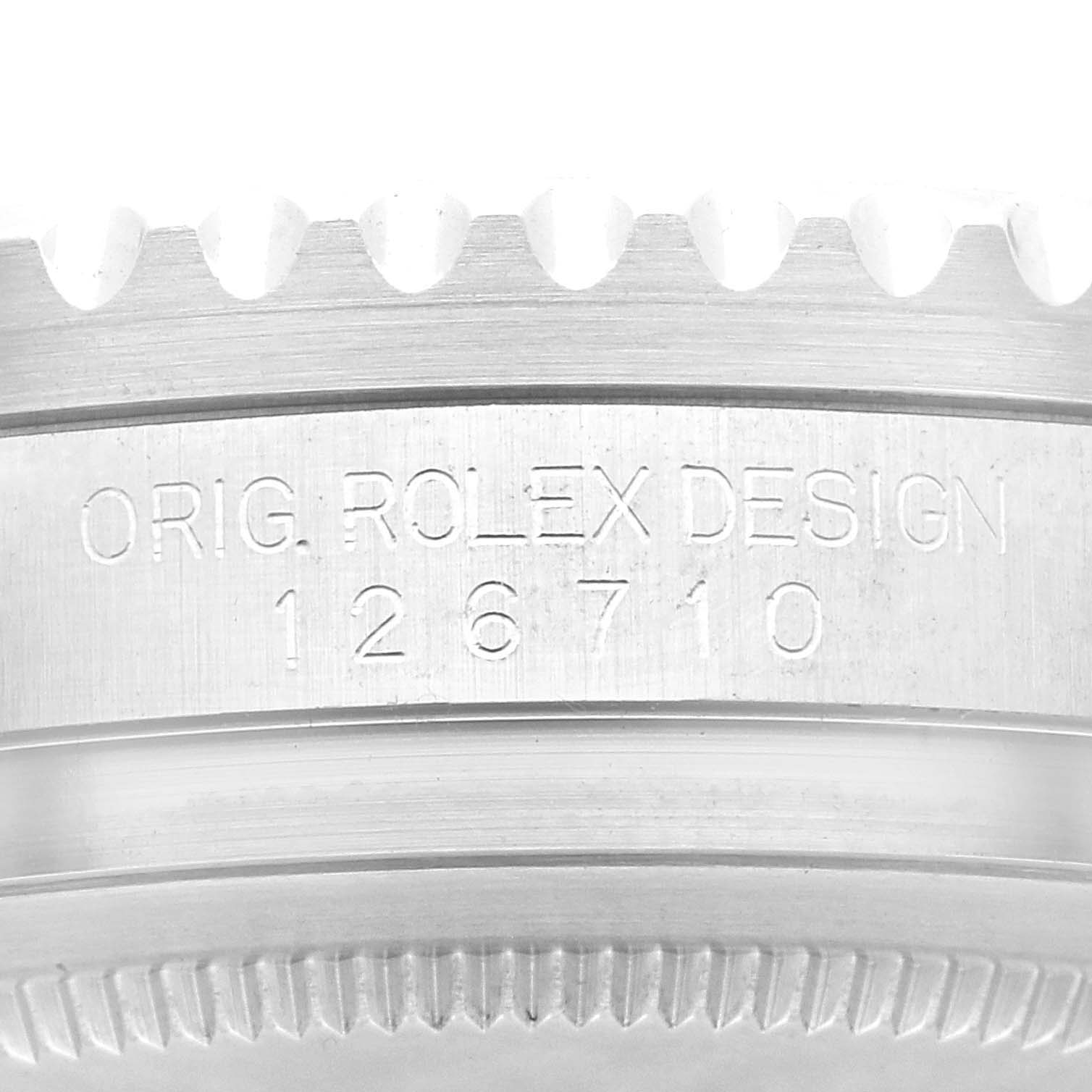 The image shows a close-up of the engraved bezel and case side of a Rolex GMT-Master 126710BLRO Men
s Stainless Steel Black Dial 126710BLRO Men
s Stainless Steel Black Dial watch, displaying "ORIG. ROLEX DESIGN 126710."