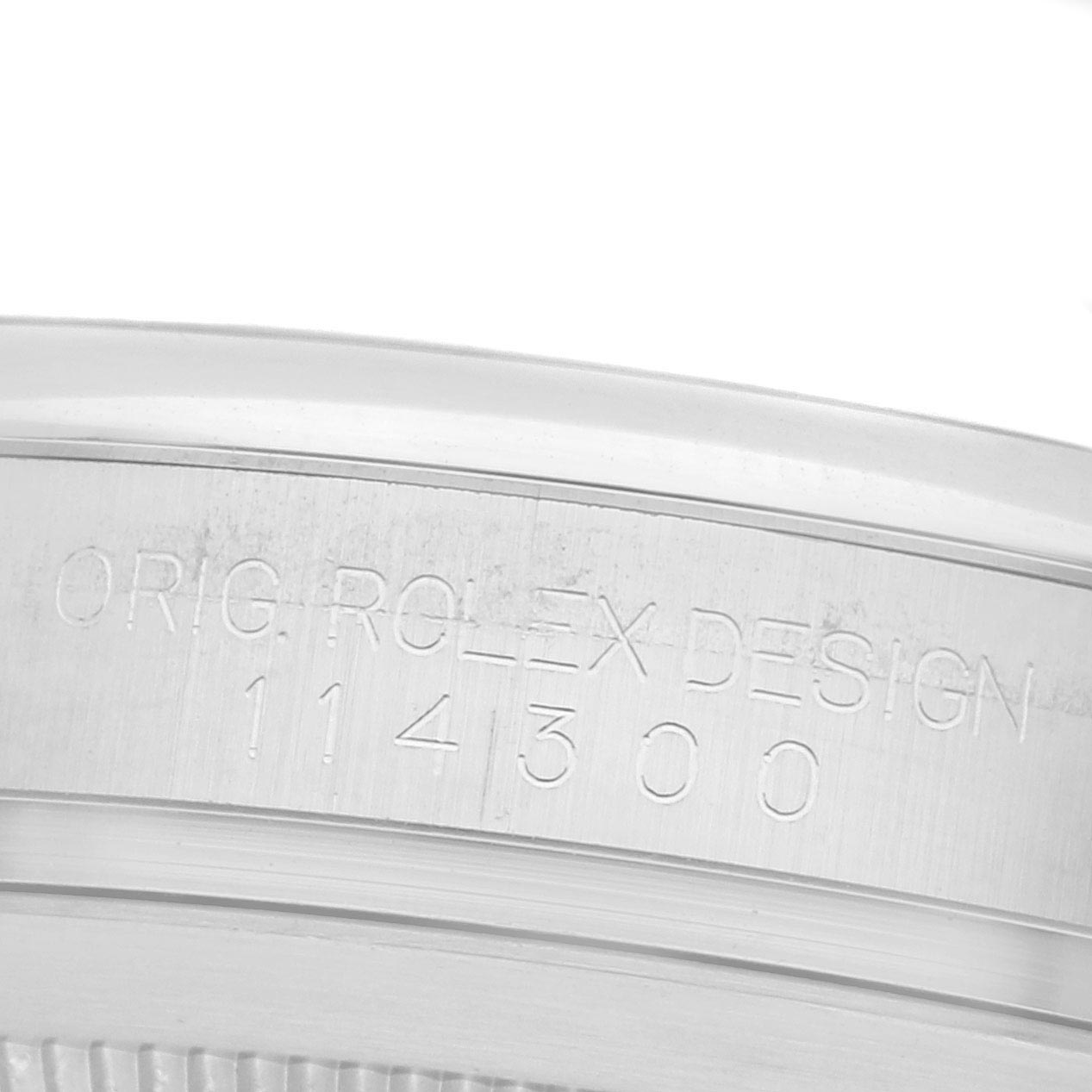 The image shows a close-up of the rim of the case back with engraved text on the Rolex Oyster Perpetual 114300 Men
s Stainless Steel Grey Dial 114300 Men
s Stainless Steel Grey Dial watch.