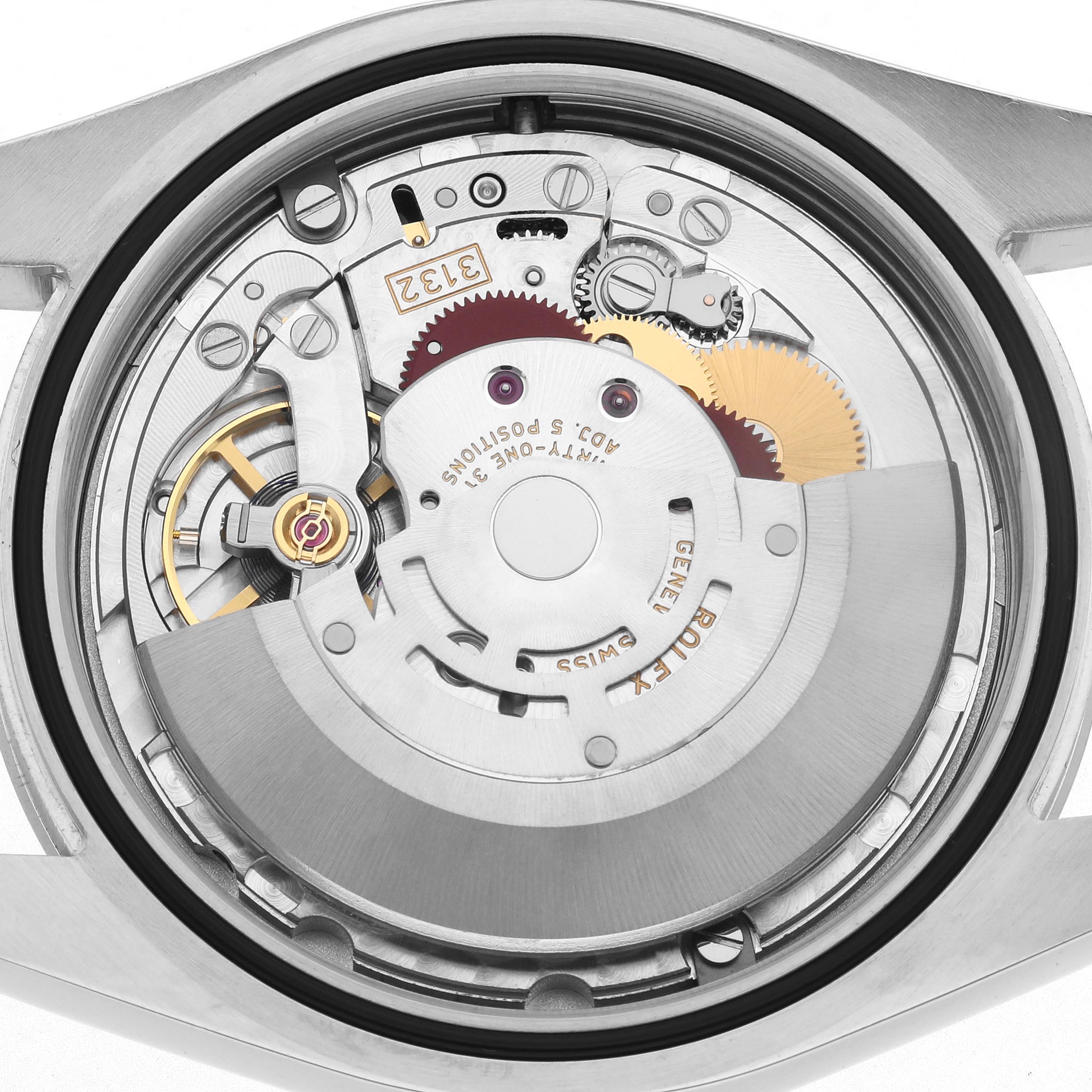 The image shows a close-up view of the Rolex Oyster Perpetual 114300 Men
s Stainless Steel Grey Dial 114300 Men
s Stainless Steel Grey Dial
s movement with gears and rotor visible.