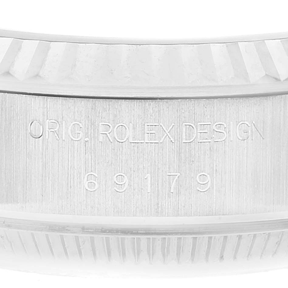 This image shows a close-up of the watch case side of a Rolex President 69179 Women's White Gold Silver Dial 69179 Women's White Gold Silver Dial model with engraved details, including the model number 69179.