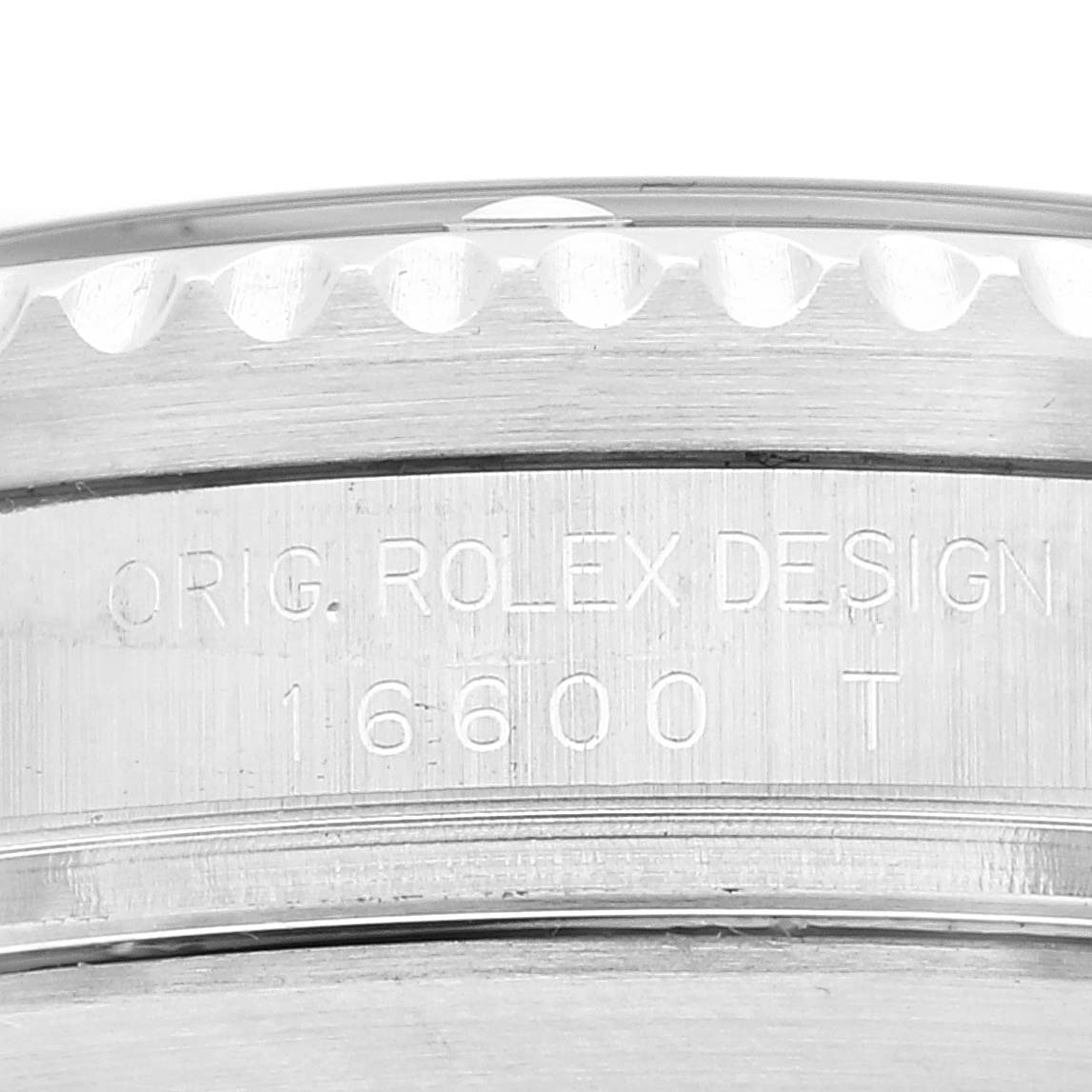 This image shows a close-up of the case side of a Rolex Sea-Dweller 16600 Men
s Stainless Steel Black Dial 16600 Men
s Stainless Steel Black Dial model 16600, displaying the engraved model number and "ORIG. ROLEX DESIGN."