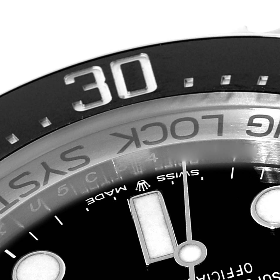 This close-up angle of the Rolex Sea-Dweller 136660 Men
s Stainless Steel Black Dial 136660 Men
s Stainless Steel Black Dial watch shows the bezel, the 
30
 minute marker, and part of the dial.