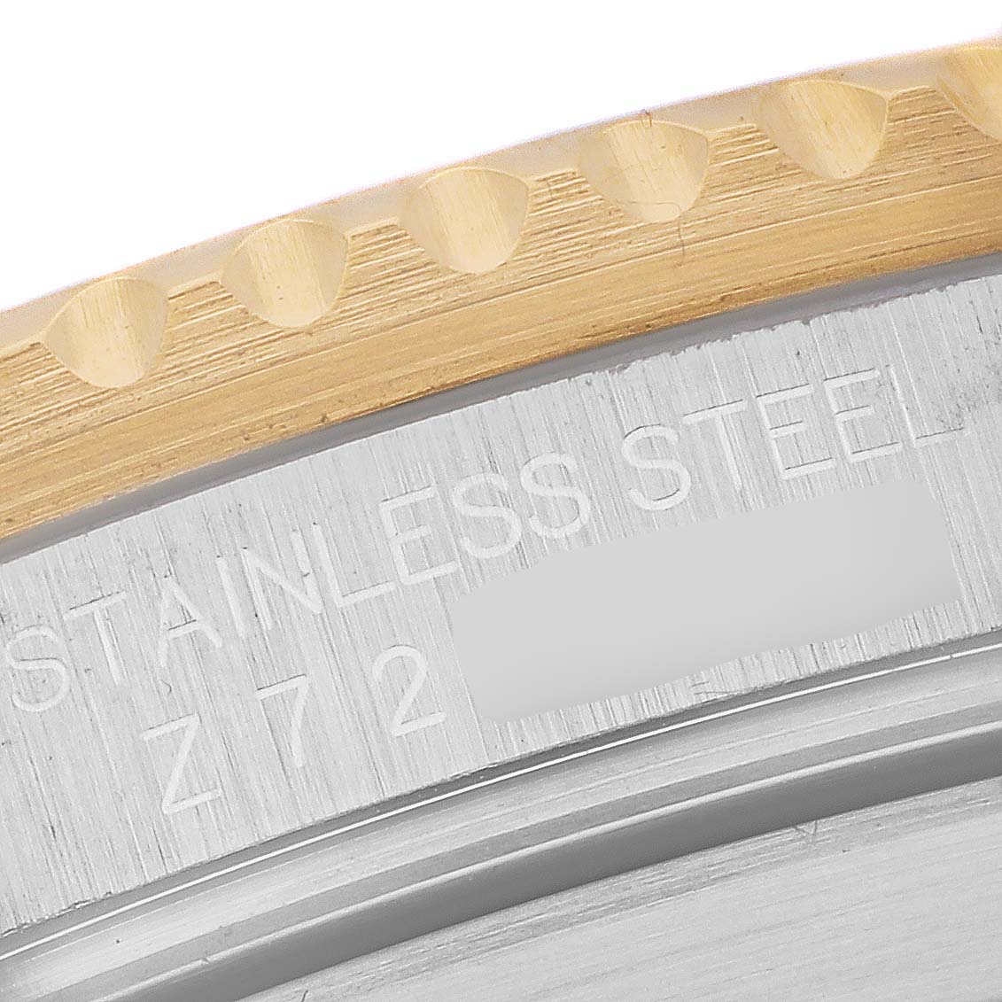 This close-up image showcases the edge of the bezel and the stainless steel engraving of a Rolex Submariner 16613 Men's Steel and Gold (two tone) Blue Dial 16613 Men's Steel and Gold (two tone) Blue Dial watch.