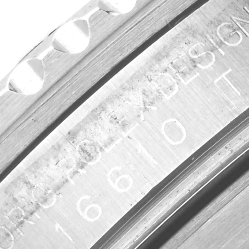 The image shows a close-up view of the bezel and engraving on the side of a Rolex Submariner 16610 Men
s Stainless Steel Black Dial 16610 Men
s Stainless Steel Black Dial watch case.