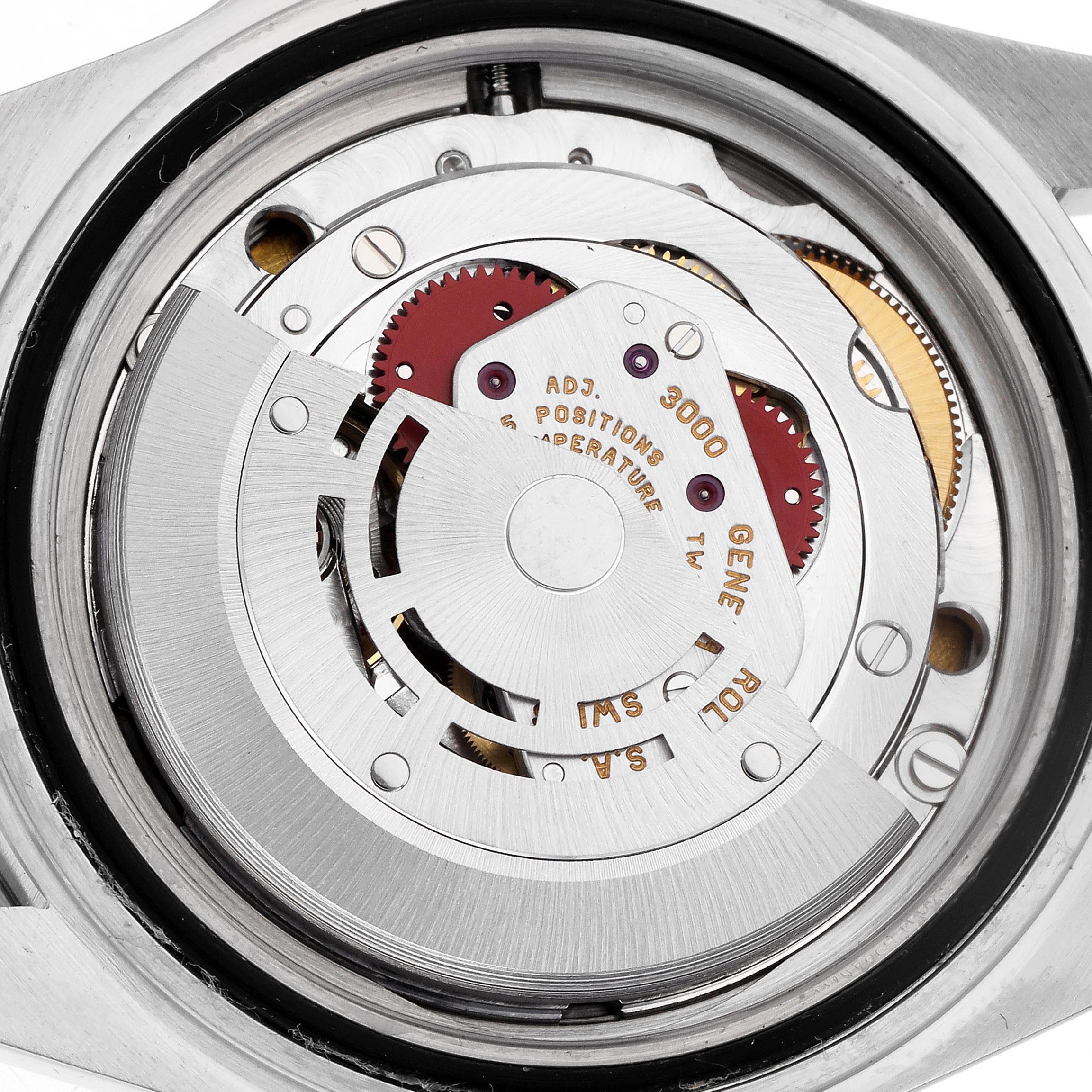 The image shows the movement of a Rolex Submariner 14060 Men
s Stainless Steel Black Dial 14060 Men
s Stainless Steel Black Dial, highlighting gears and inscriptions from a rear angle.