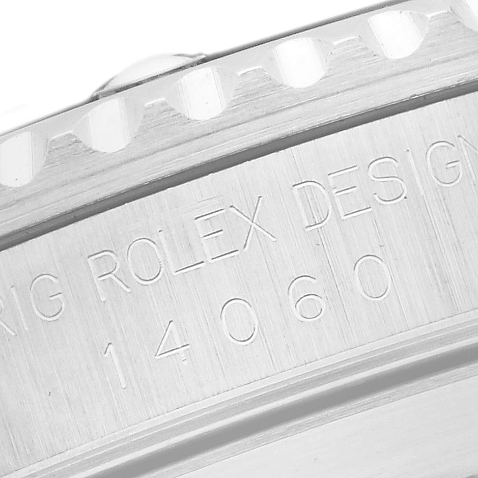 The image shows a close-up of the side of the bezel and engravings on a Rolex Submariner 14060 Men
s Stainless Steel Black Dial 14060 Men
s Stainless Steel Black Dial watch.
