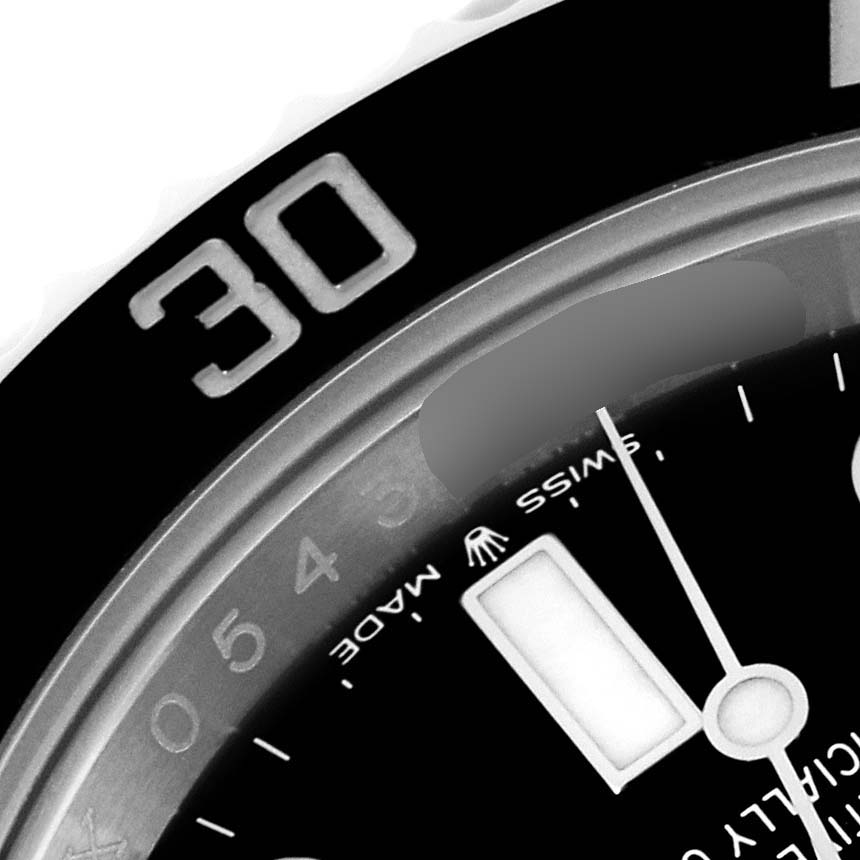 This image shows a close-up of the bezel, part of the dial, and the minute hand of a Rolex Submariner 124060 Men
s Stainless Steel Black Dial 124060 Men
s Stainless Steel Black Dial watch.