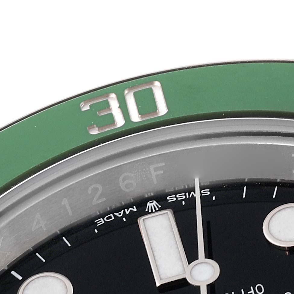 This close-up image shows part of the bezel, dial, and minute hand of the Rolex Submariner 126610LV Men's Stainless Steel Black Dial 126610LV Men's Stainless Steel Black Dial watch.
