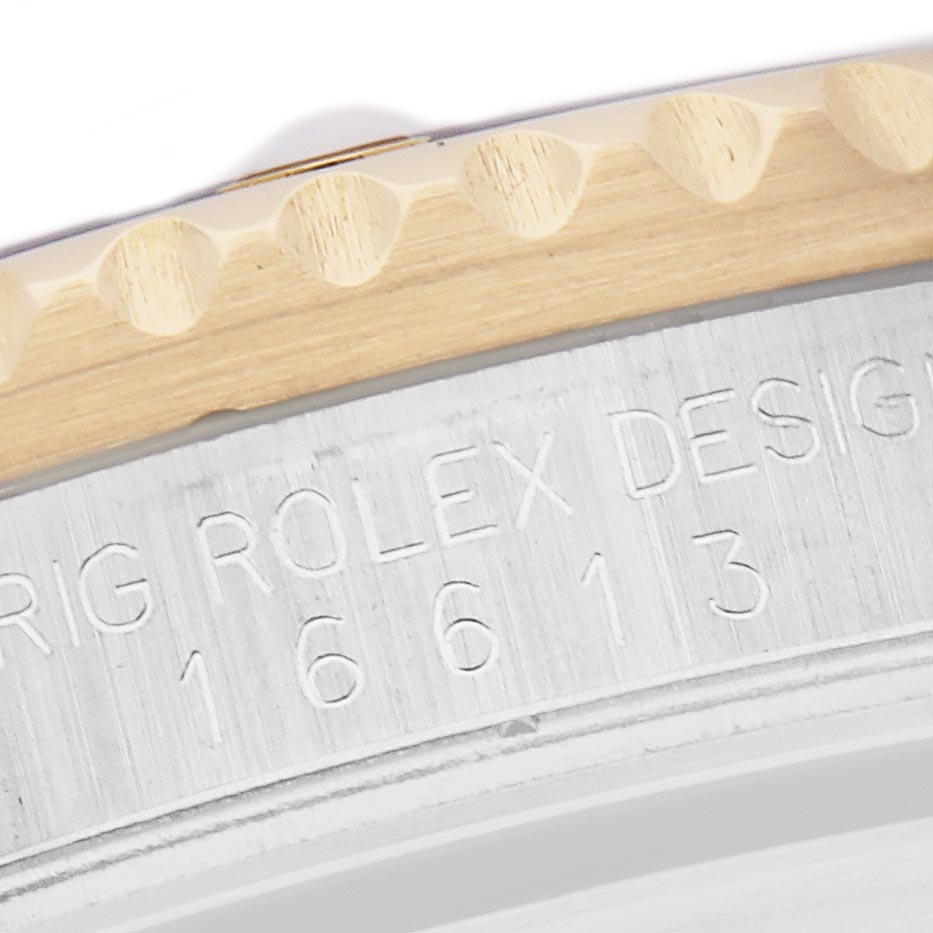The image shows a close-up of the side engraving on the case of a Rolex Submariner 16613 Men
s Steel and Gold (two tone) Champagne Dial 16613 Men
s Steel and Gold (two tone) Champagne Dial, highlighting the model number.