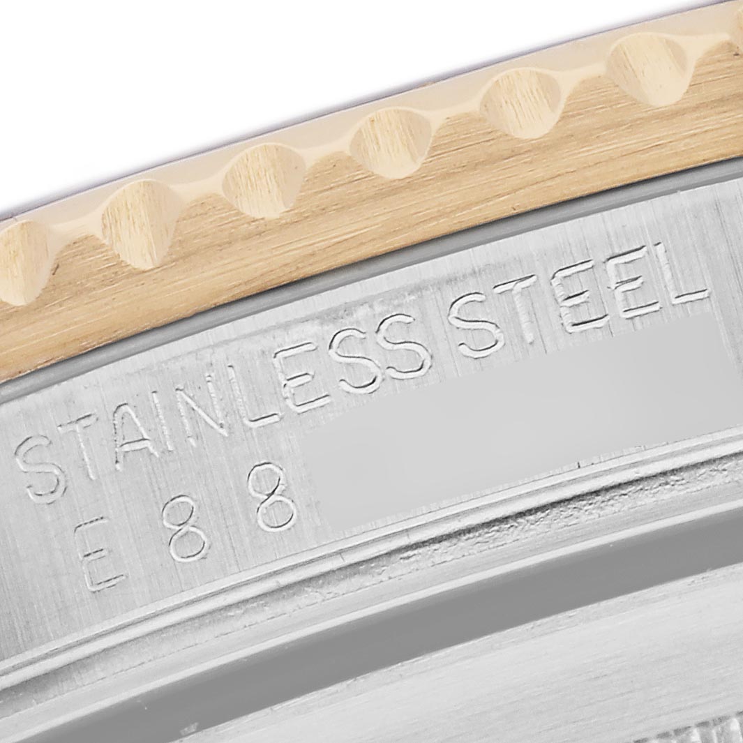 The image shows a close-up of the side engraving on a Rolex Submariner 16613 Men
s Steel and Gold (two tone) Champagne Dial 16613 Men
s Steel and Gold (two tone) Champagne Dial, highlighting "STAINLESS STEEL."