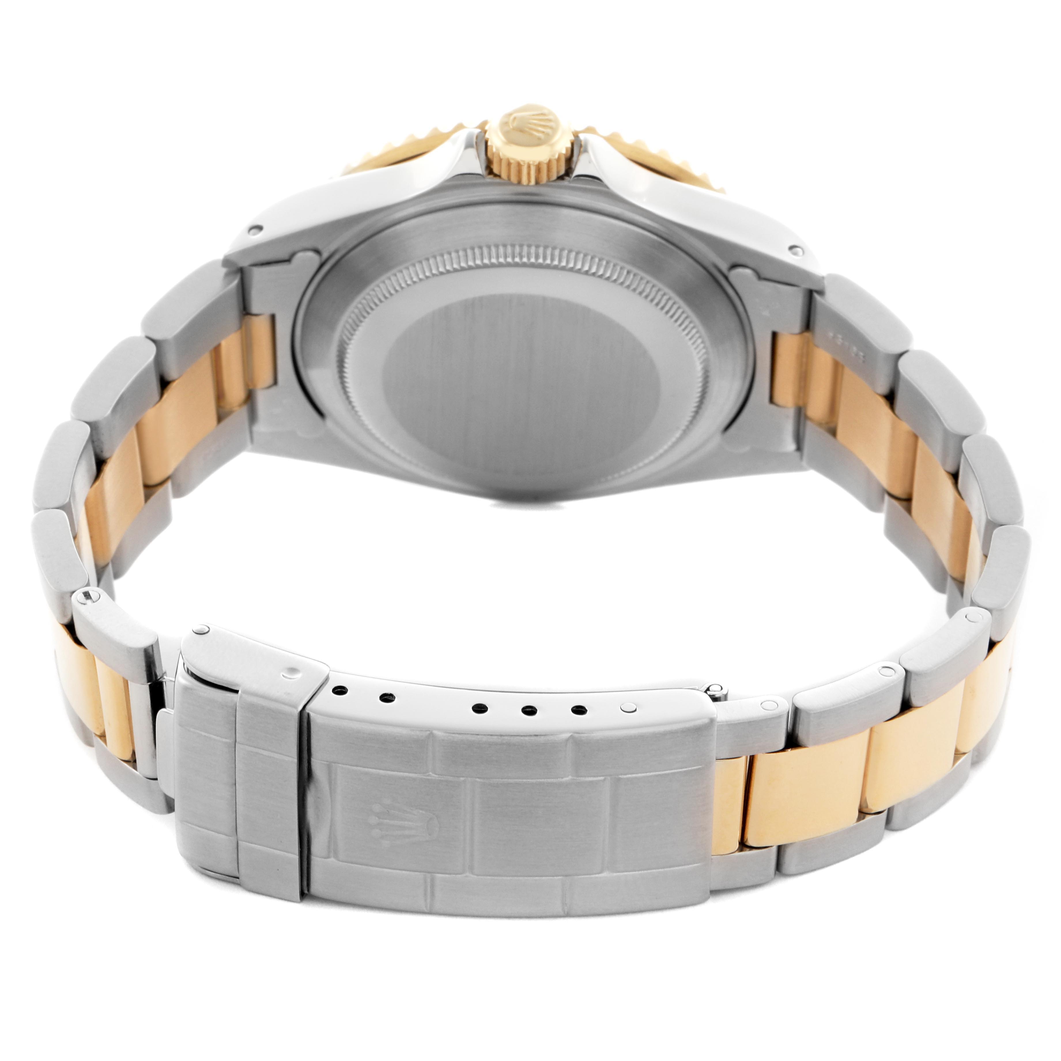 The image shows the back and side view of a Rolex Submariner 16613 Men
s Steel and Gold (two tone) Champagne Dial 16613 Men
s Steel and Gold (two tone) Champagne Dial, highlighting its case, crown, and two-tone bracelet with clasp.