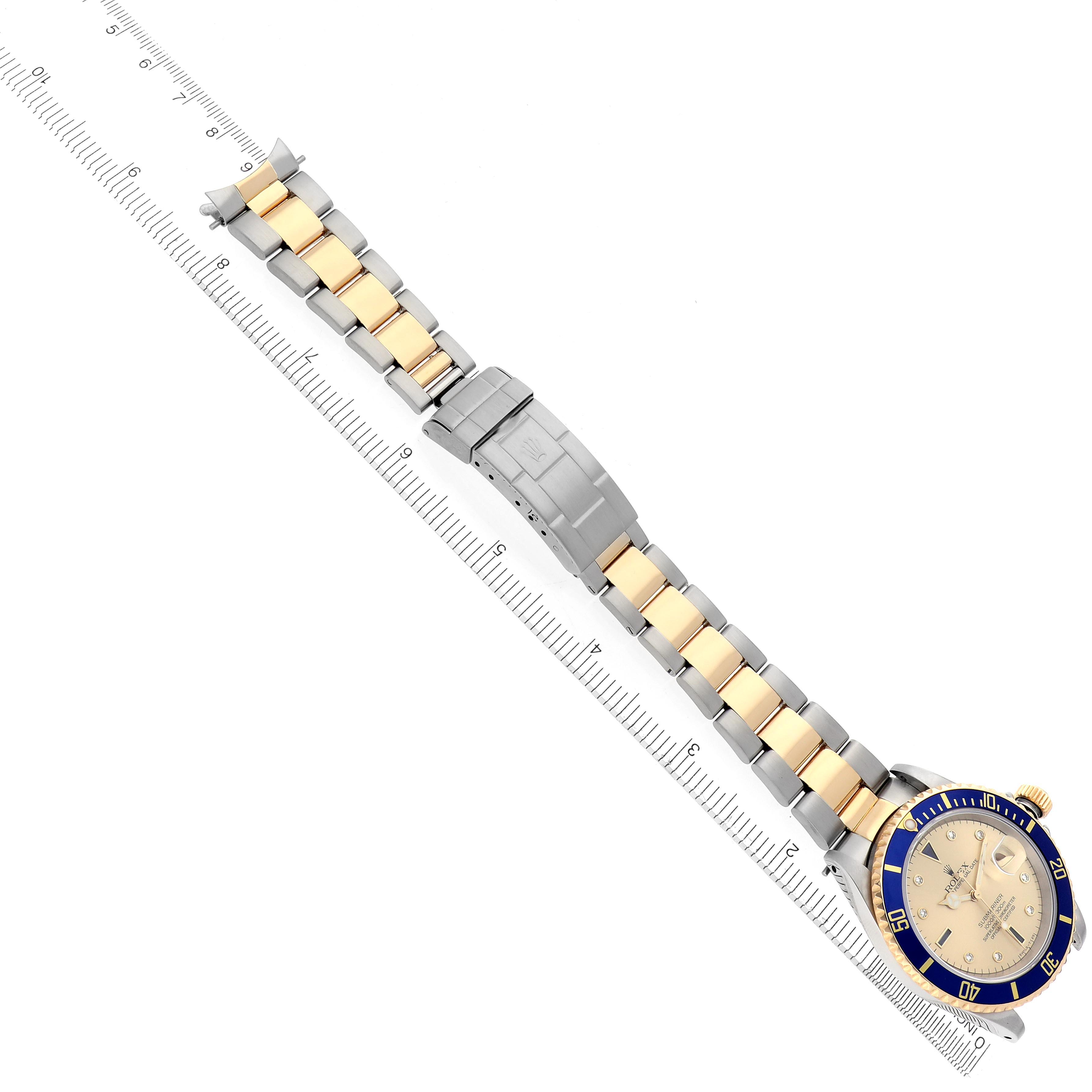 The Rolex Submariner 16613 Men
s Steel and Gold (two tone) Champagne Dial 16613 Men
s Steel and Gold (two tone) Champagne Dial watch is displayed at an angle showing the full bracelet, clasp, and face with a blue bezel and gold accents.