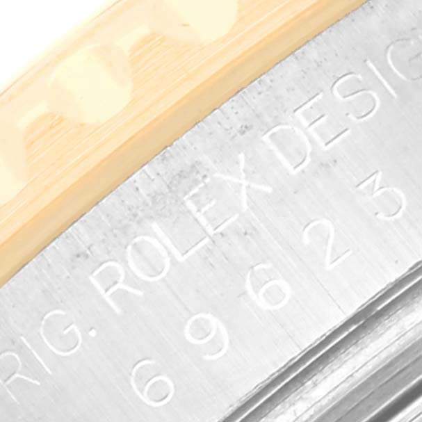 Close-up view of the side of the Rolex Yacht-Master 69623 Women's Steel and Gold (two tone) White Dial 69623 Women's Steel and Gold (two tone) White Dial watch showing the engraved model and bezel.