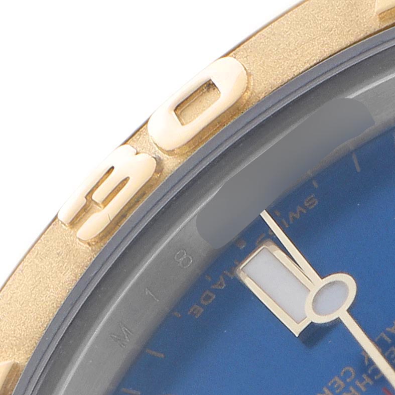 The image shows a close-up of the dial and bezel of a Rolex Yacht-Master 168623 Men
s Steel and Gold (two tone) Blue Dial 168623 Men
s Steel and Gold (two tone) Blue Dial watch, highlighting the gold detailing and blue face.