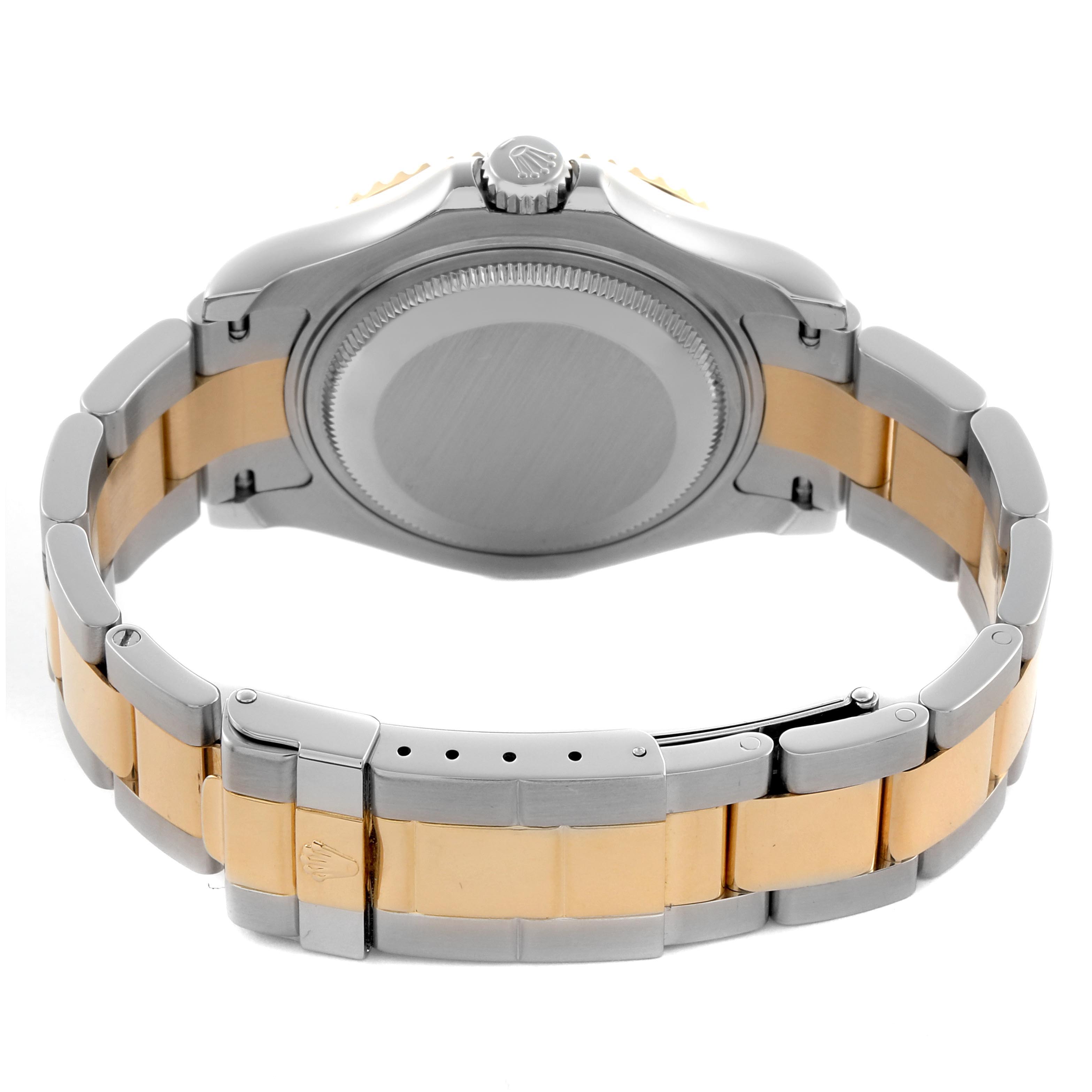 The image shows the back of the Rolex Yacht-Master 168623 Men
s Steel and Gold (two tone) Blue Dial 168623 Men
s Steel and Gold (two tone) Blue Dial watch, highlighting its stainless steel and gold bracelet and the closed clasp.