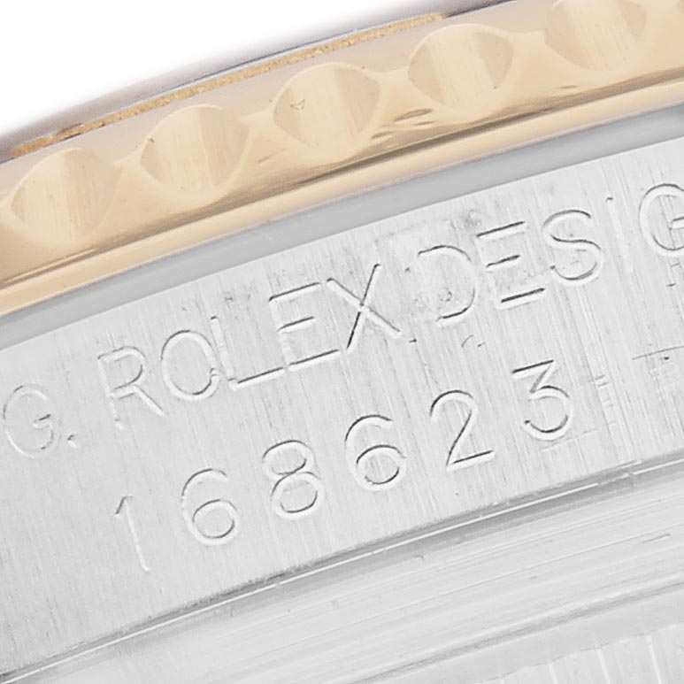 The image shows a close-up of the engraved case side of a Rolex Yacht-Master 168623 Men
s Steel and Gold (two tone) Blue Dial 168623 Men
s Steel and Gold (two tone) Blue Dial, focusing on the reference number.
