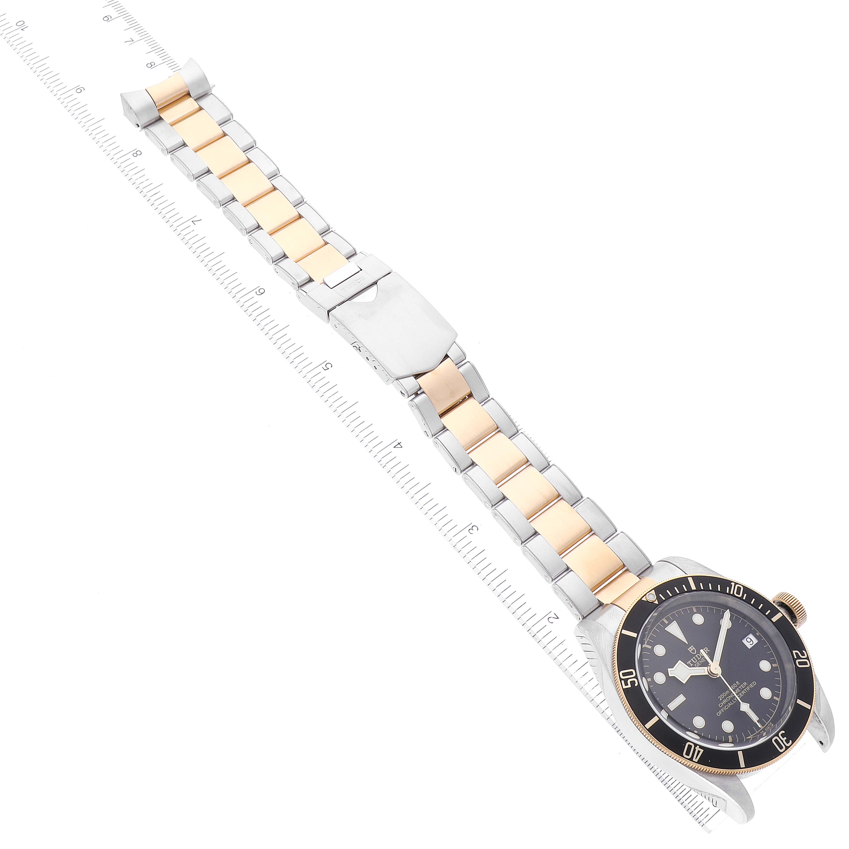 The image shows a Tudor Heritage Black Bay 79733 Men's Steel and Gold (two tone) Black Dial 79733 Men's Steel and Gold (two tone) Black Dial watch displayed in a diagonal angle, highlighting the dial, bezel, and two-tone bracelet.