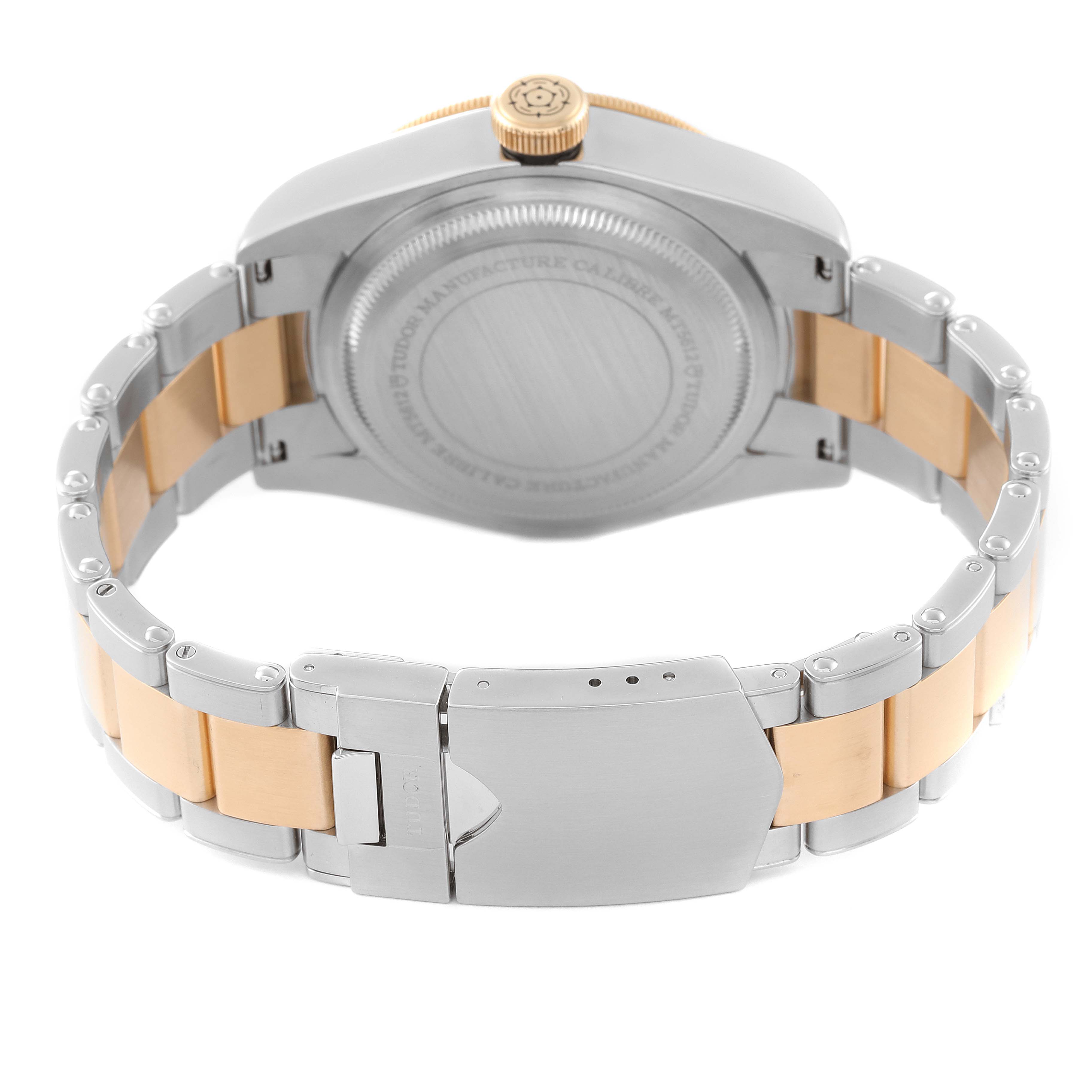 The image shows the back view of a Tudor Heritage Black Bay 79733 Men's Steel and Gold (two tone) Black Dial 79733 Men's Steel and Gold (two tone) Black Dial watch, highlighting its case back, crown, and metal bracelet.