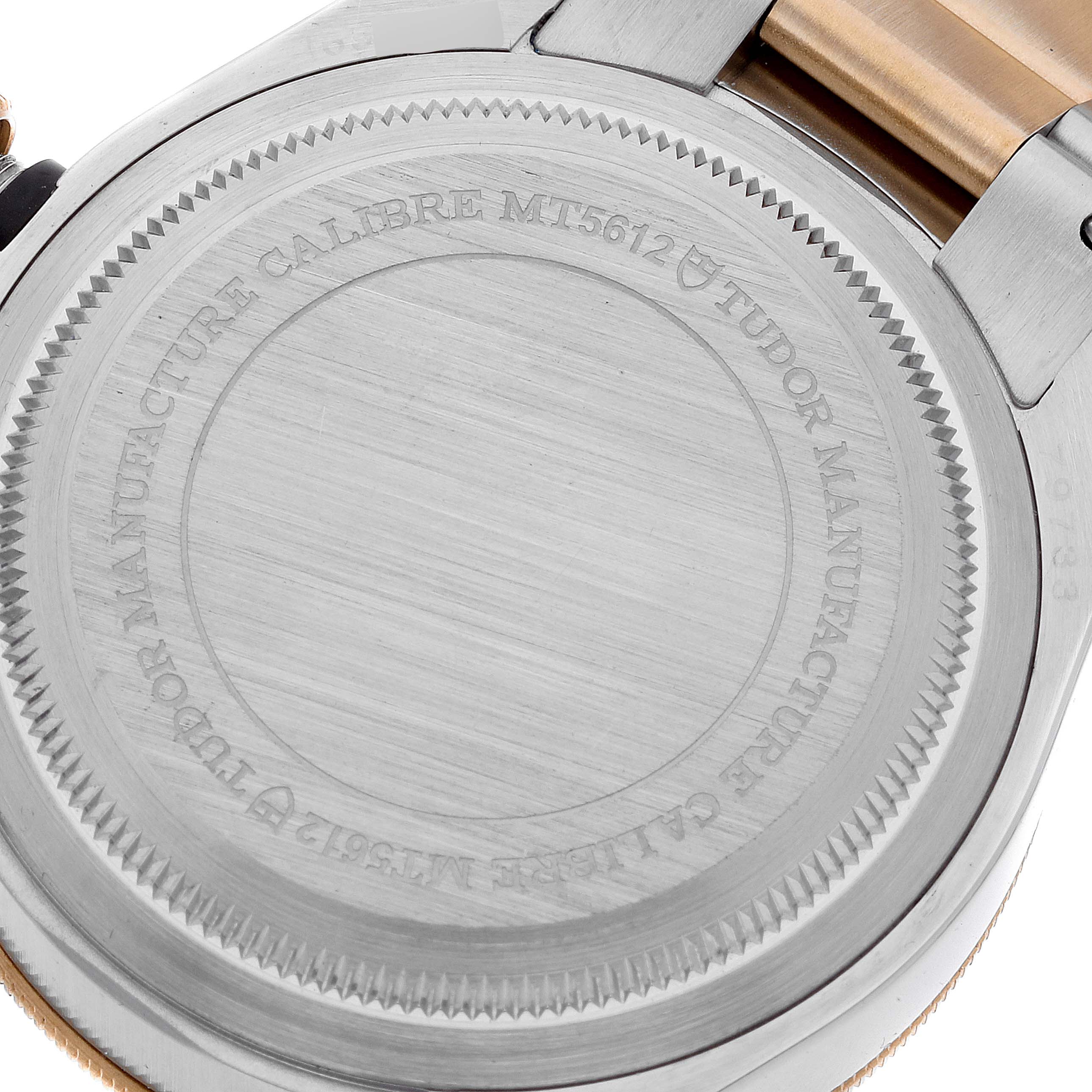 The image shows the back case of the Tudor Heritage Black Bay 79733 Men's Steel and Gold (two tone) Black Dial 79733 Men's Steel and Gold (two tone) Black Dial watch, highlighting its calibre and engraving details.