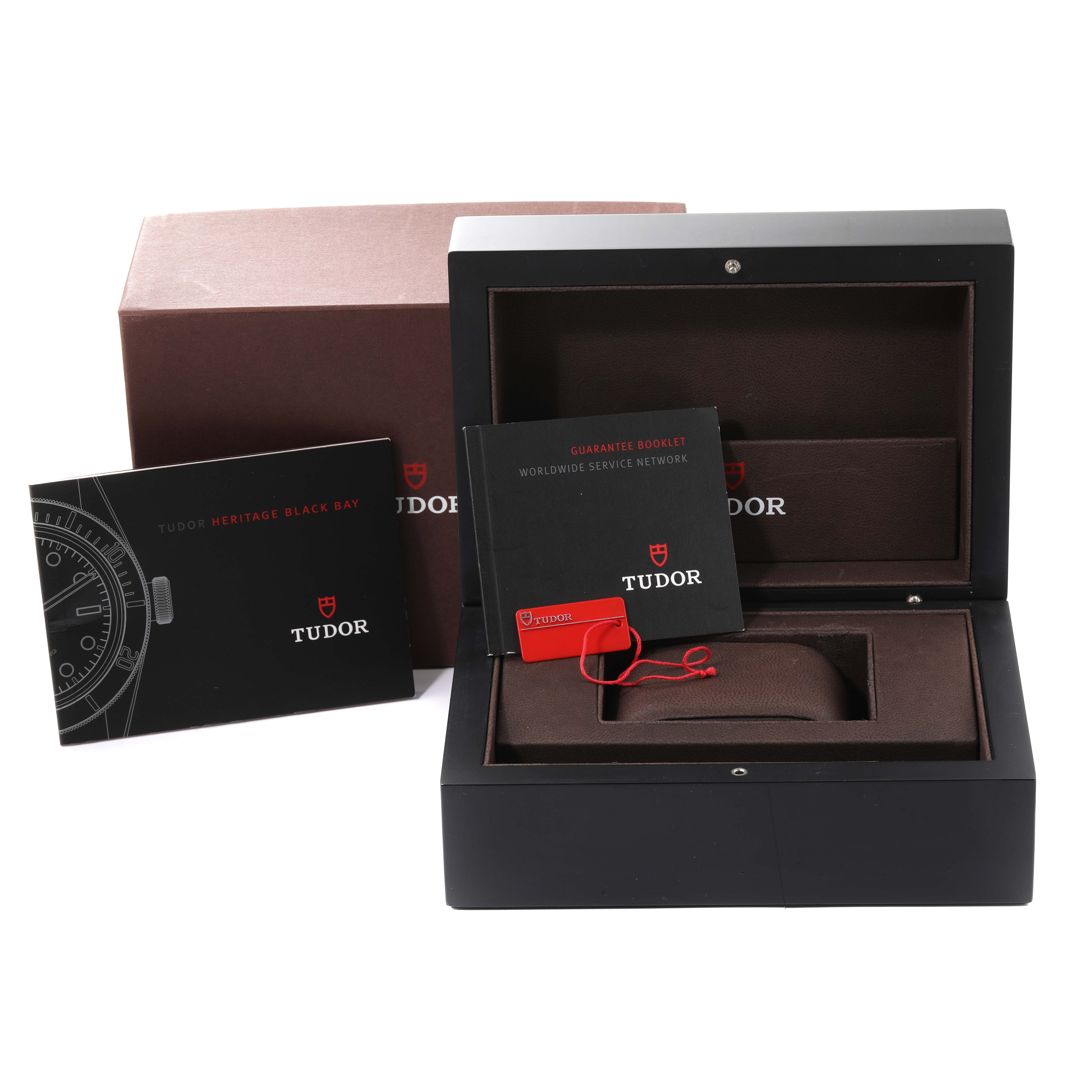 This image shows the Tudor Heritage Black Bay 79220R Men's Stainless Steel Black Dial 79220R Men's Stainless Steel Black Dial watch box, its guarantee booklet, and the outer packaging from a front angle.