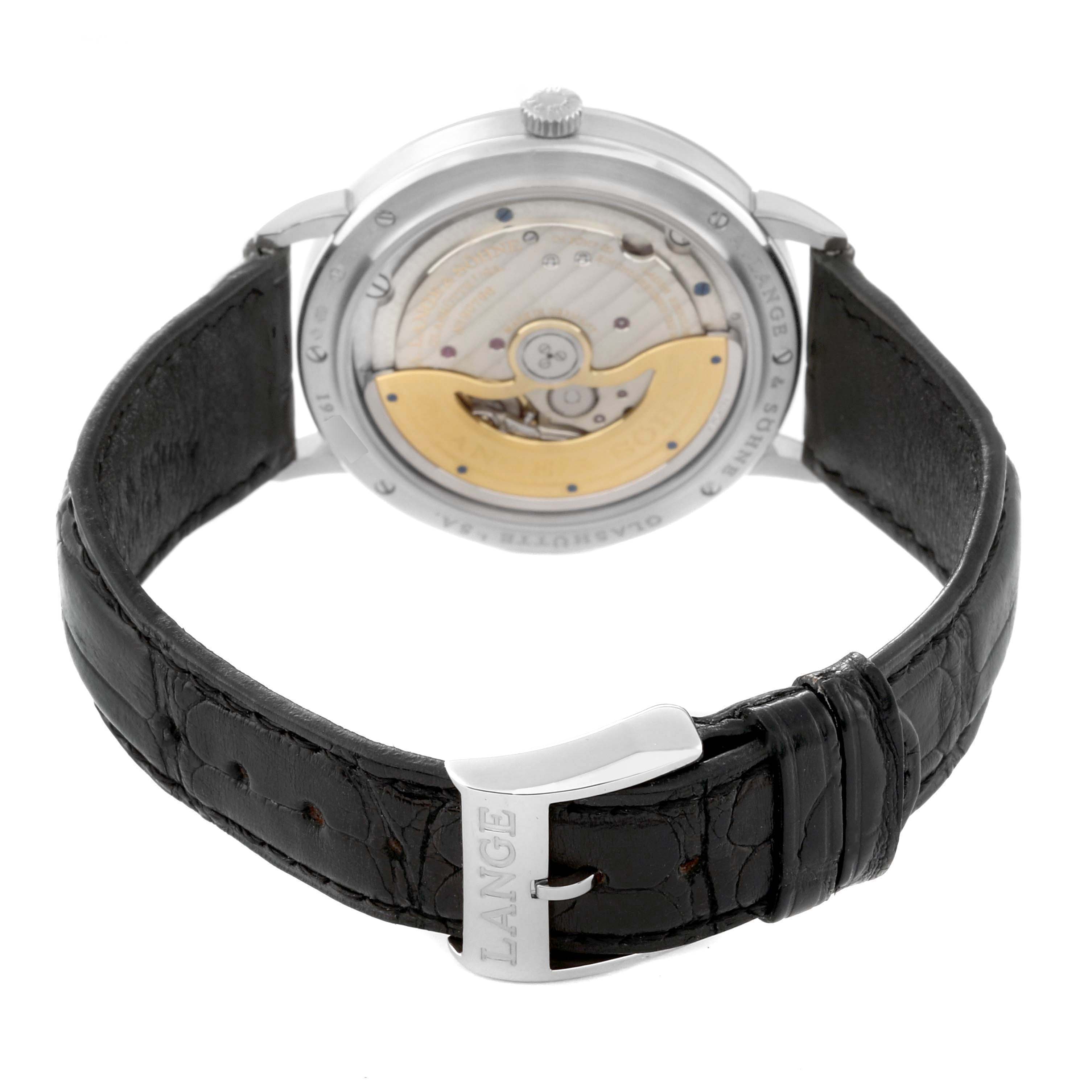 The image shows the case back of the A. Lange & Sohne Saxonia 380.026 Men's White Gold Silver Dial watch, highlighting its movement and leather strap clasp.