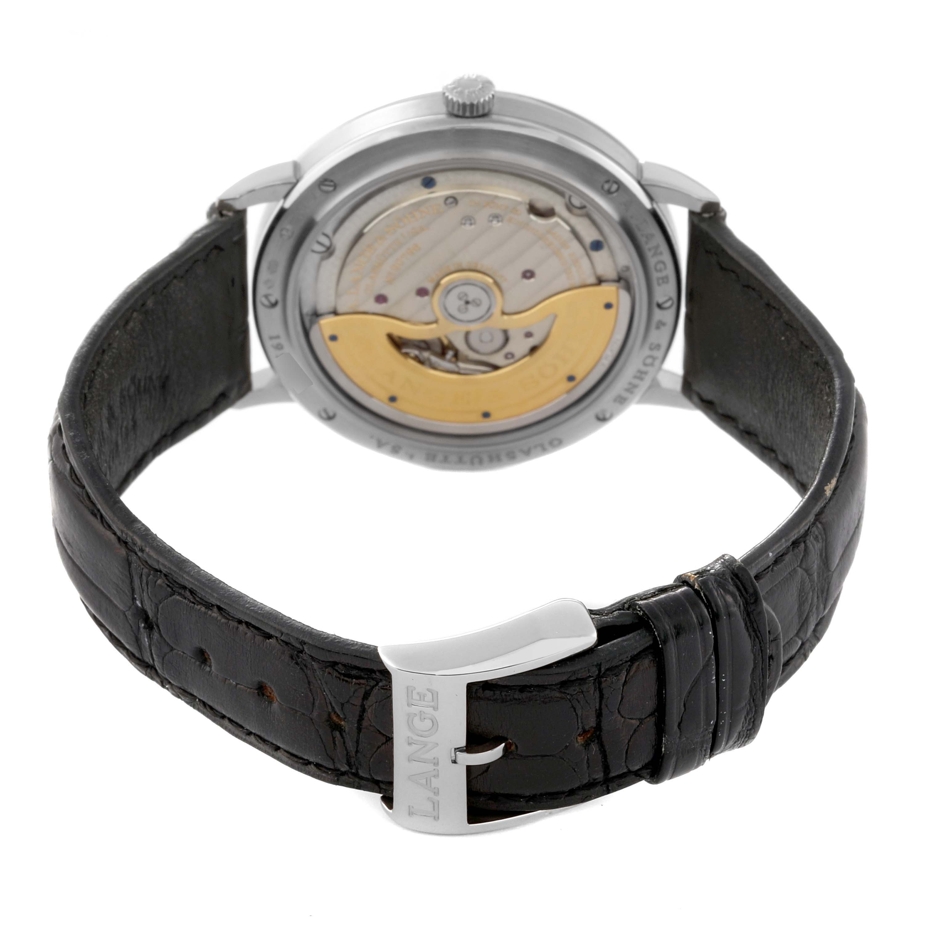 The image shows the back angle of the A. Lange 
Sohne Saxonia 380.026 Men
s White Gold Silver Dial watch, displaying its movement and leather strap with a buckle.